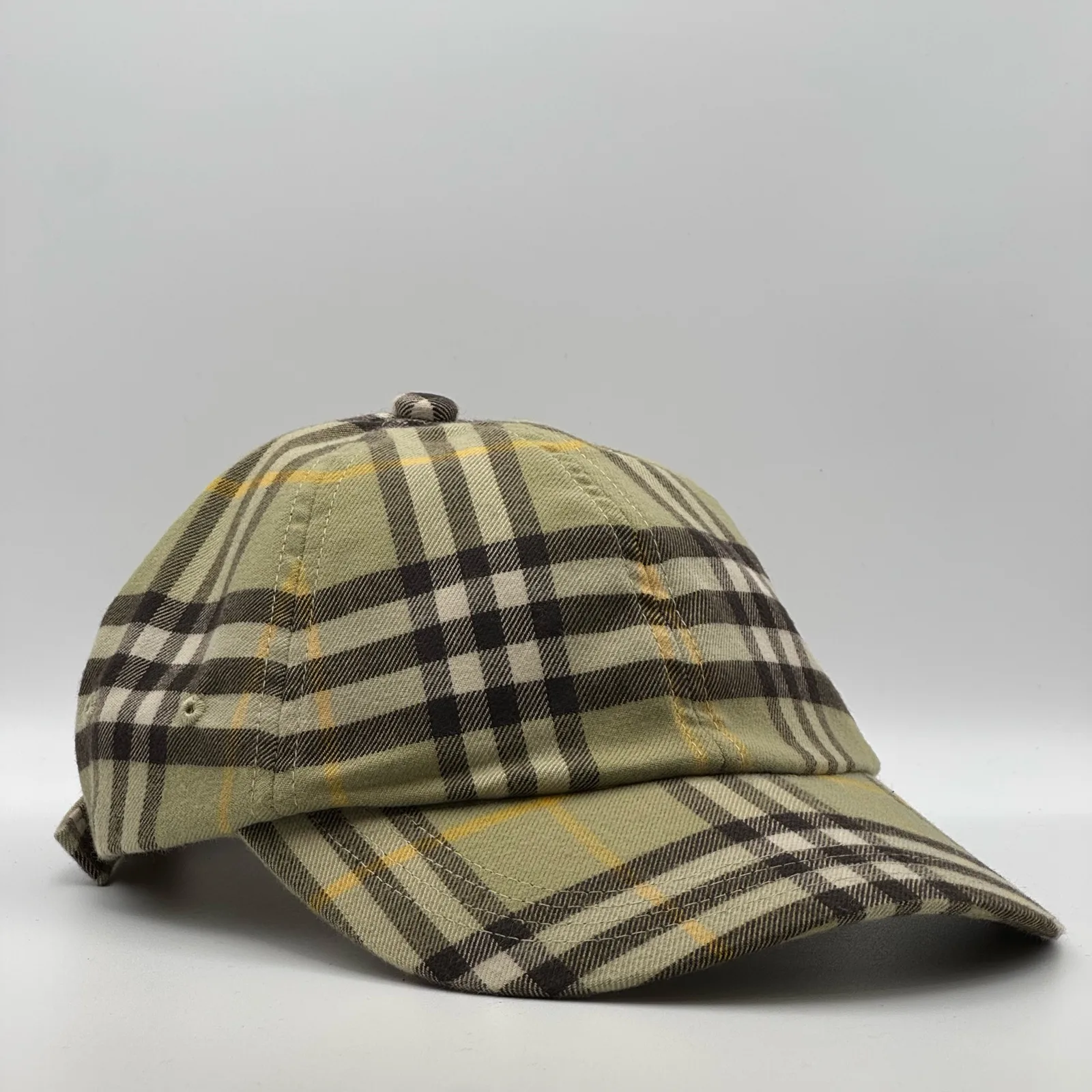 Olive check Burberry cap, side profile.
