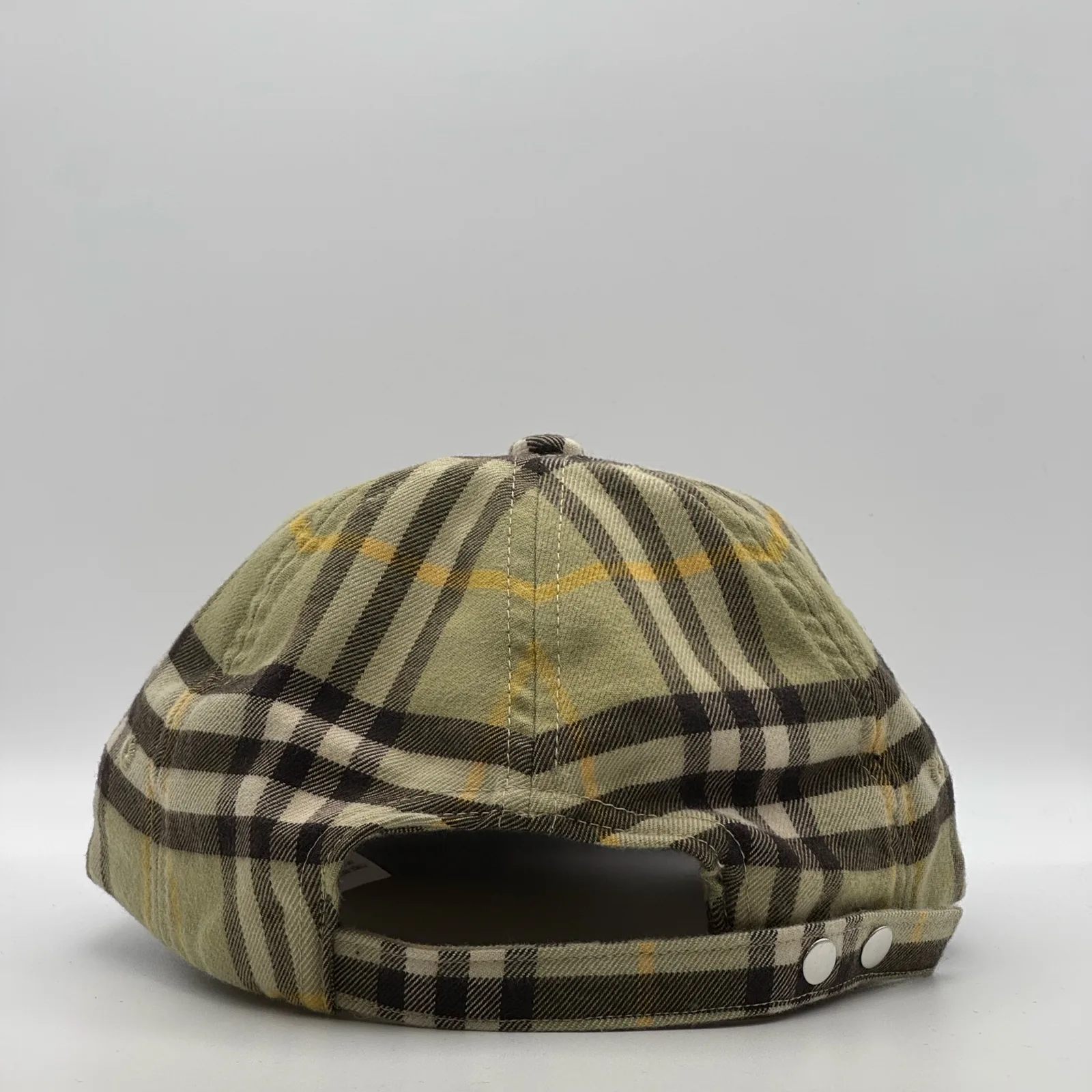 Olive check Burberry cap, back view showing the snap-button strap.