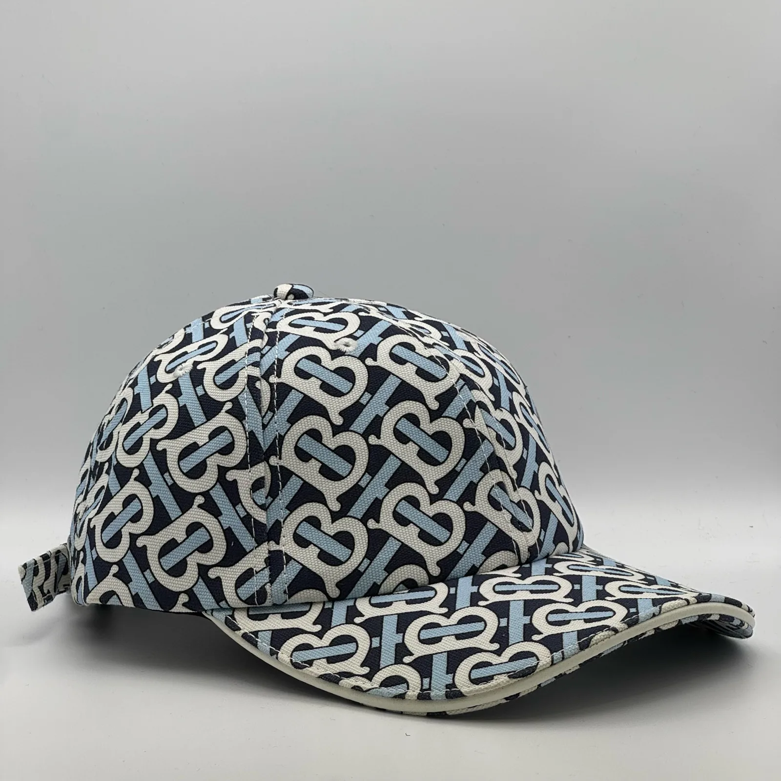 Navy Burberry TB Monogram cap, side profile.