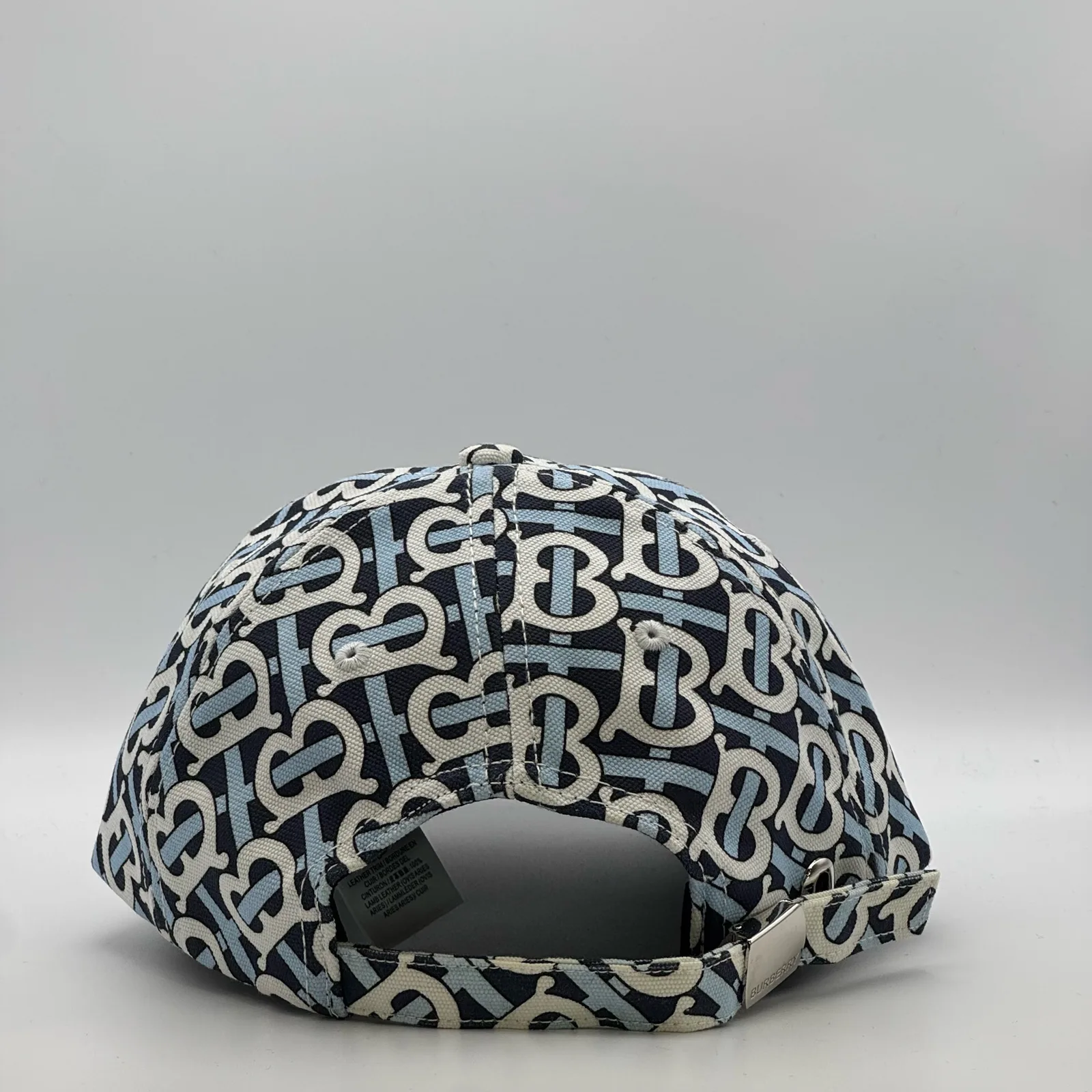Navy Burberry TB Monogram cap, back view showing the open adjuster strap.