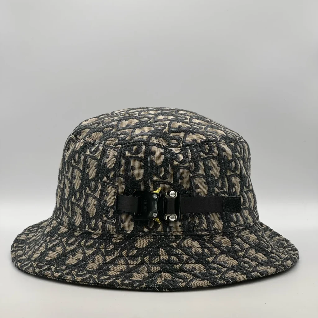 Dior Oblique bucket hat in navy and beige, side view showing the buckle strap.