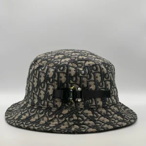 Dior Oblique bucket hat in navy and beige, side view showing the buckle strap.