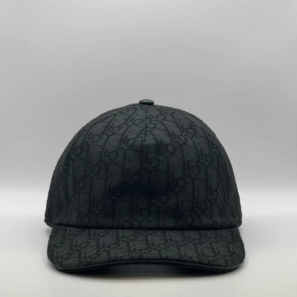 Black Dior Oblique cap, front view showing the tonal jacquard pattern.