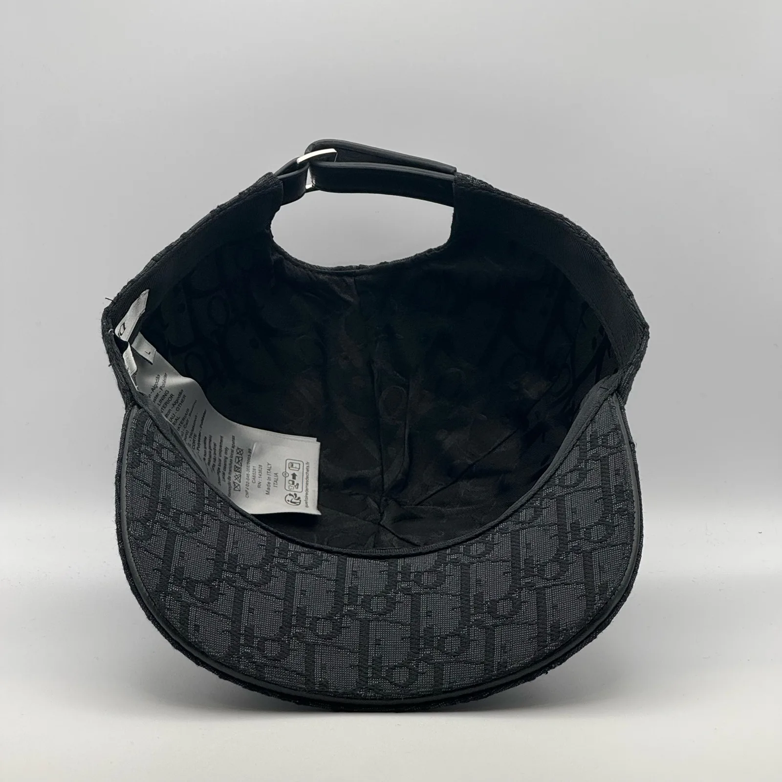Inside view of the black Dior Oblique cap showing the brand tag.