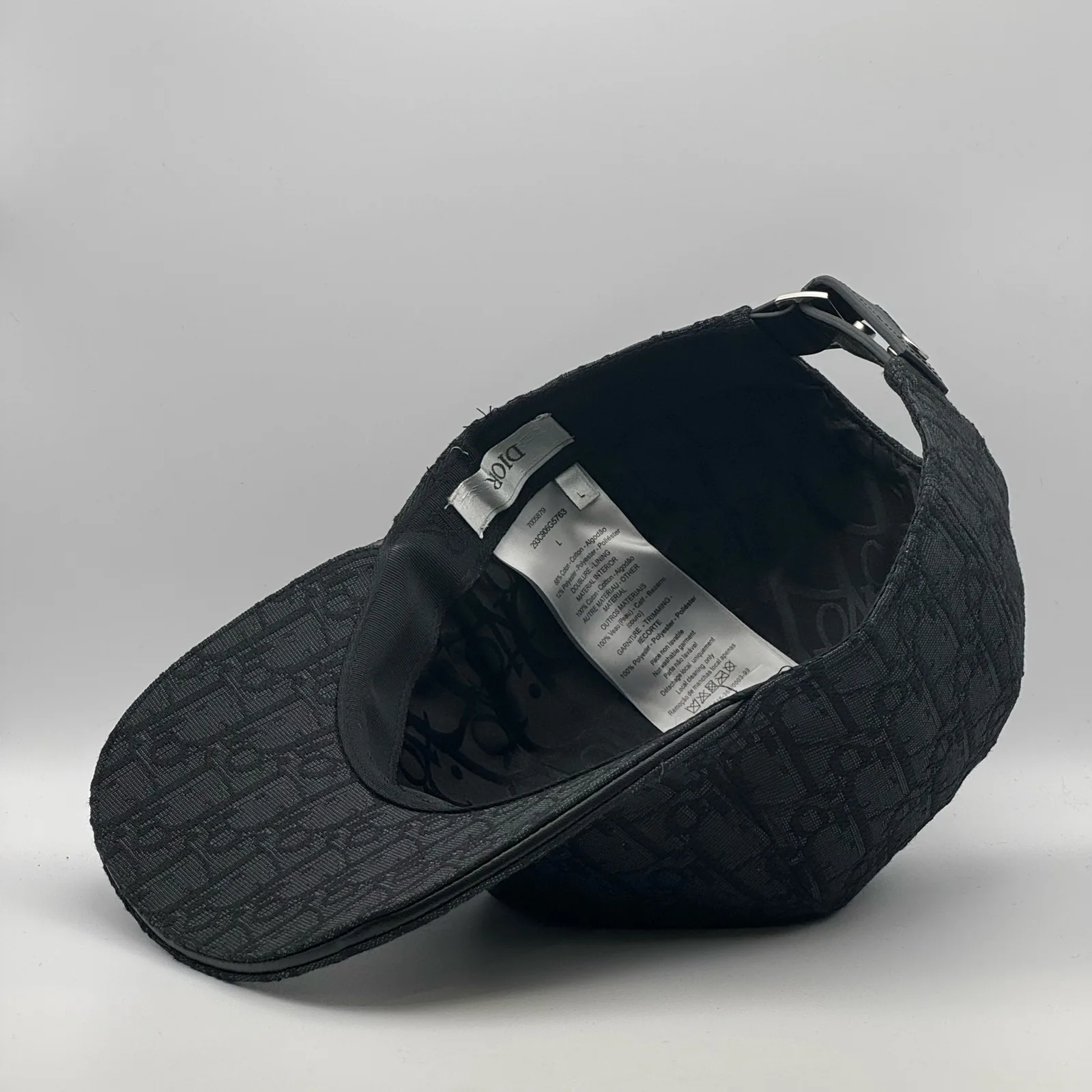 Angled inside view of the black Dior Oblique cap and strap.
