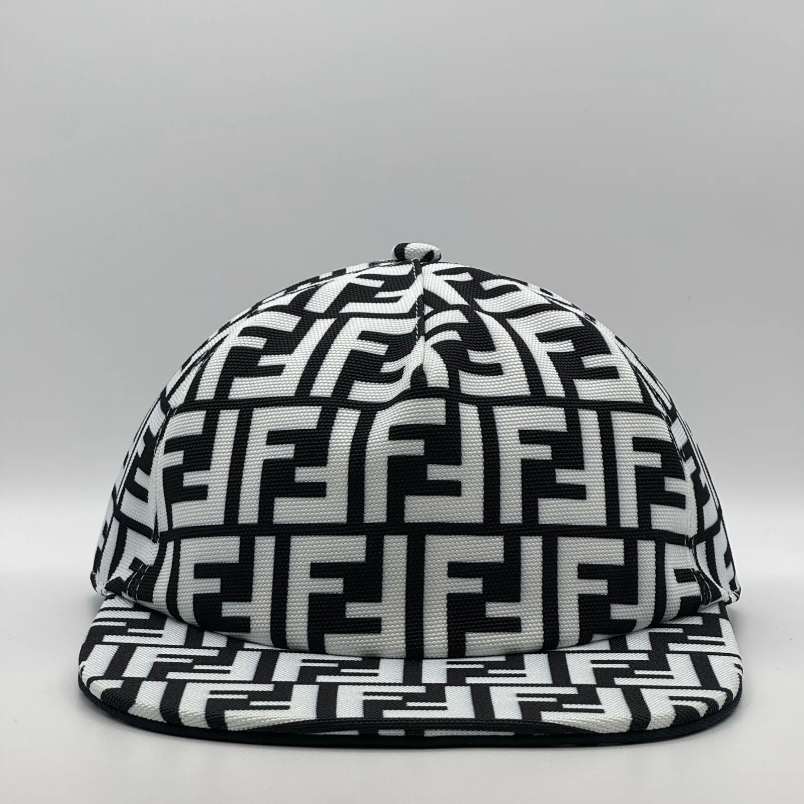Black and white Fendi FF cap, three-quarter front view.