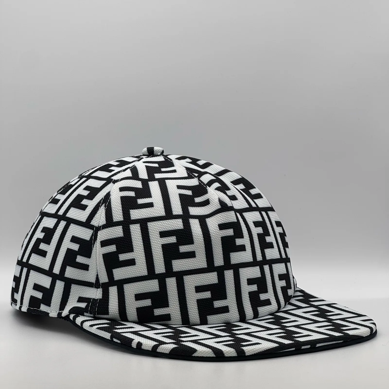 Black and white Fendi FF cap, side profile showing the curved brim.