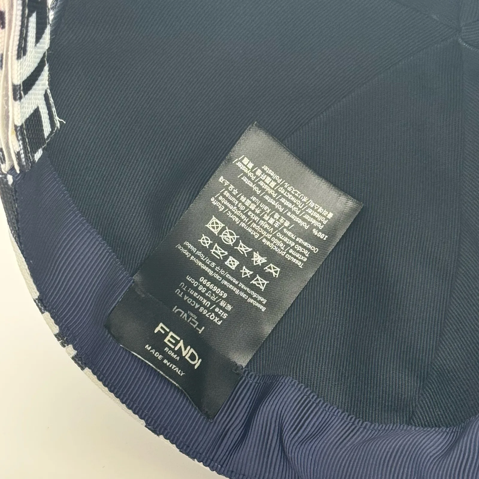 Close-up of the care label stitched inside the black and white FF cap.