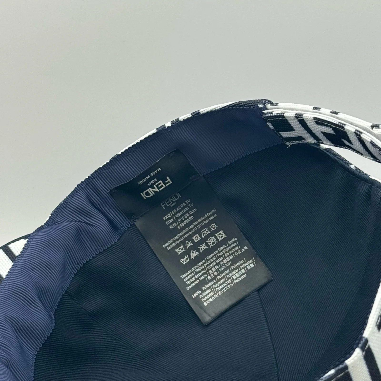 Close-up of the Fendi brand tag inside the black and white FF cap.