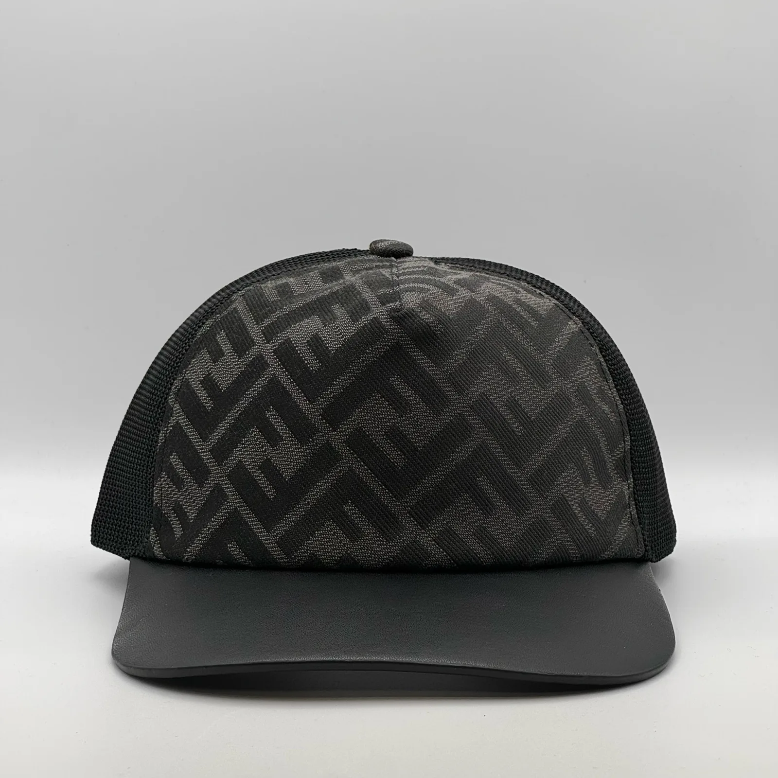 Black Fendi FF trucker cap, three-quarter front-left view.
