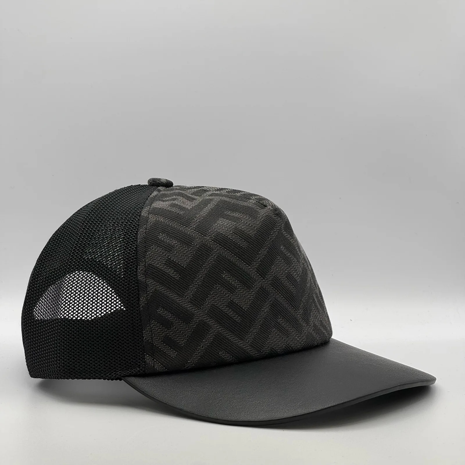 Black Fendi FF trucker cap, side profile showing the mesh back panel.