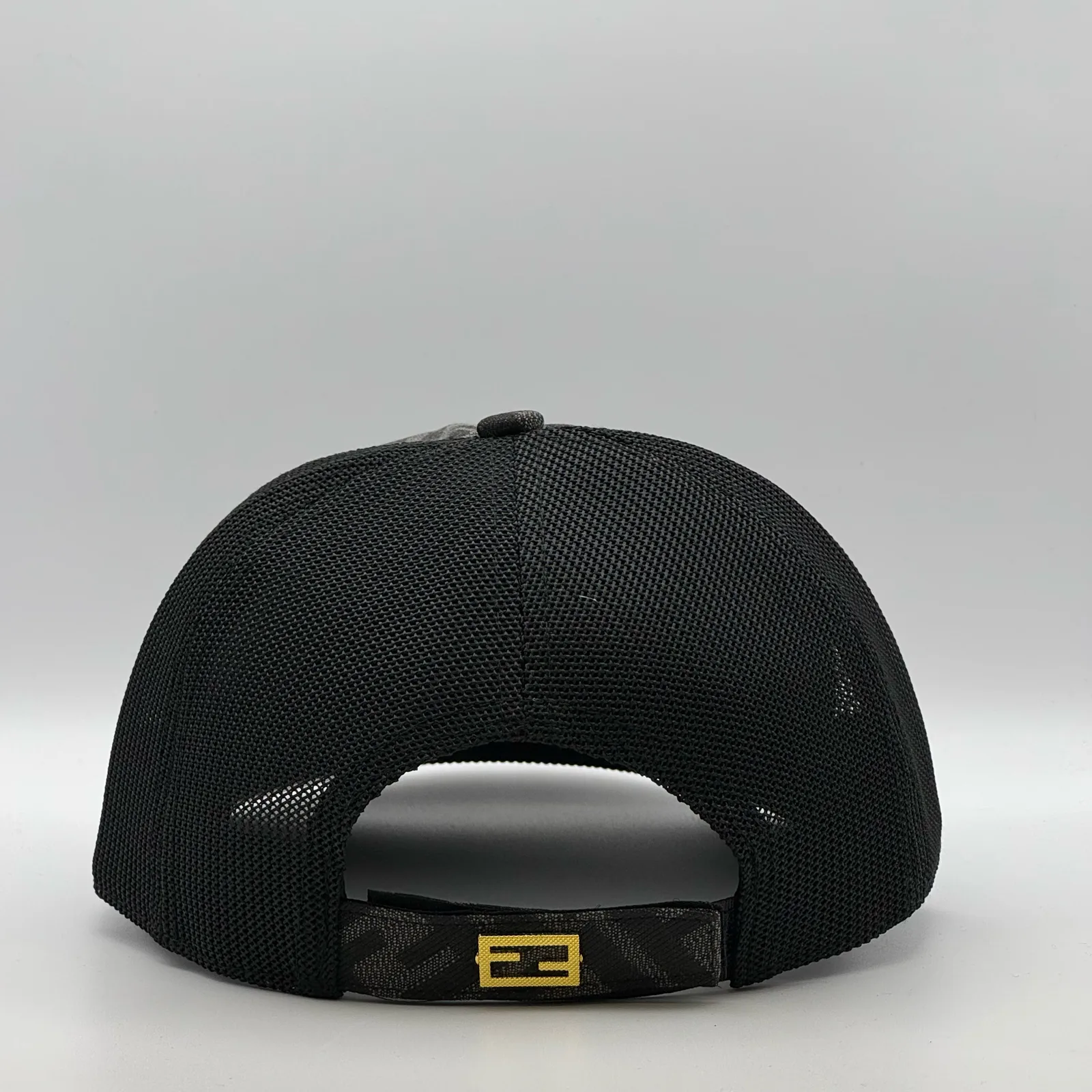 Black Fendi FF trucker cap, back view showing the mesh panel and gold-tone FF tab.