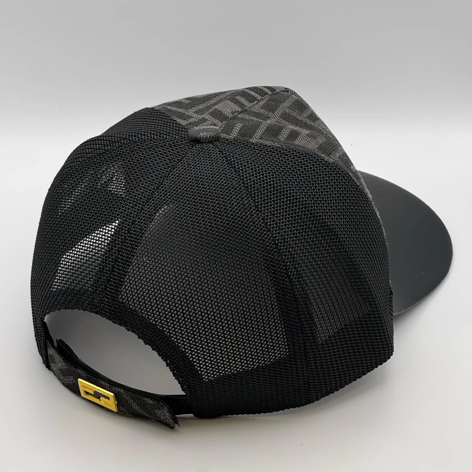 Black Fendi FF trucker cap, elevated three-quarter view of the back and crown.