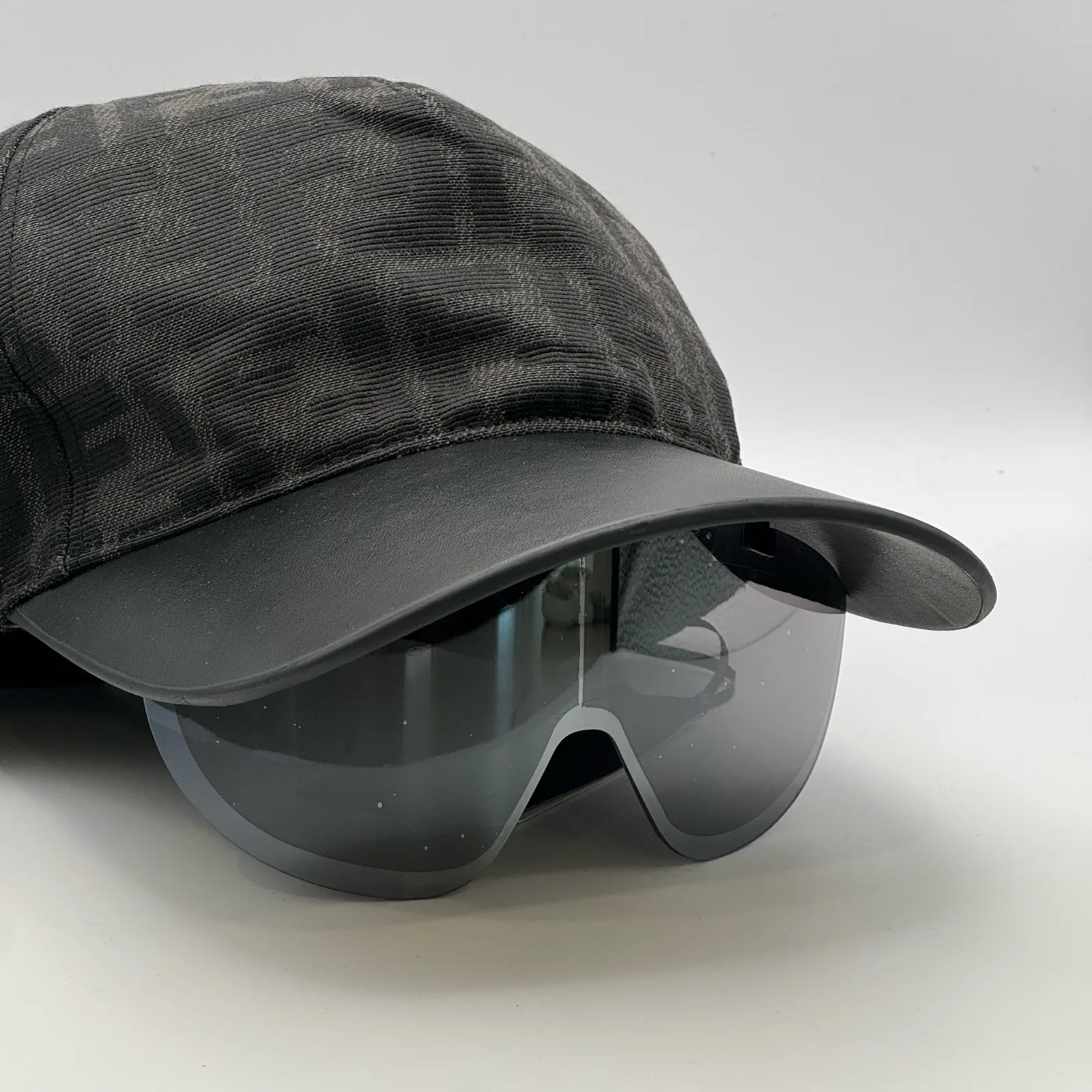 Close-up of the tinted visor shield on the black Fendi cap.