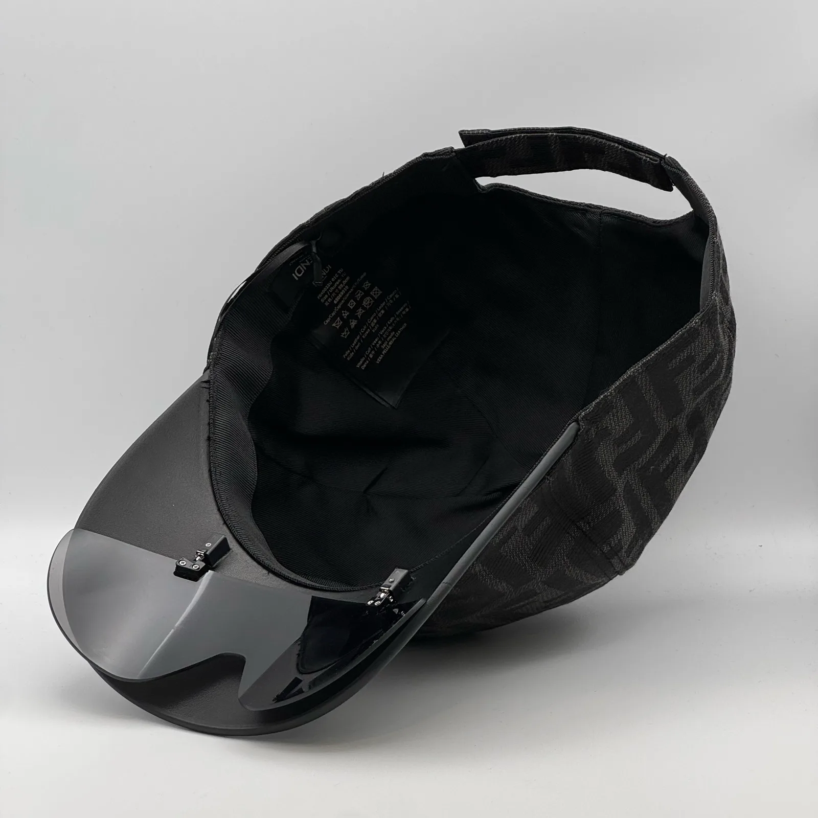 Underside of the black Fendi Visor cap, showing the visor shield from inside.