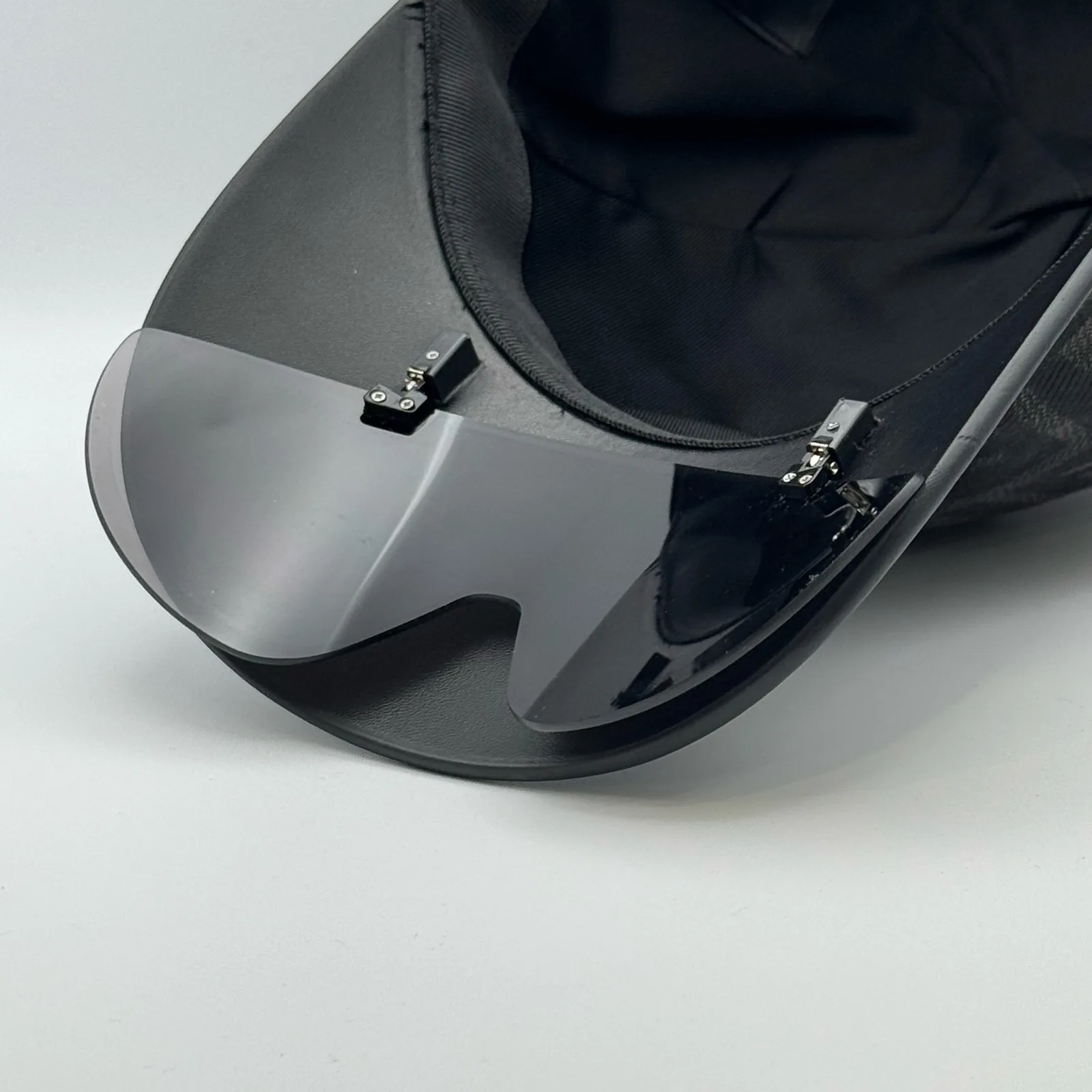 Close-up of the visor shield's underside on the black Fendi cap.