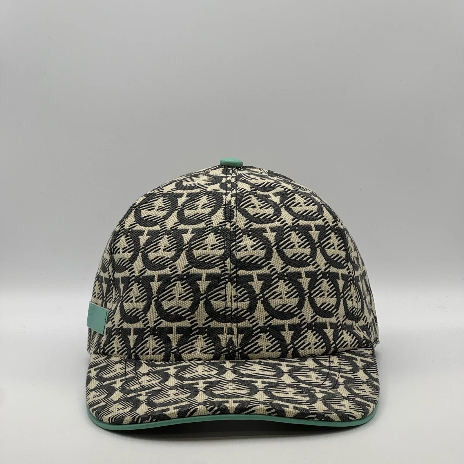 Ferragamo Gancini cap, front view in cream and charcoal weave with a mint green trim.