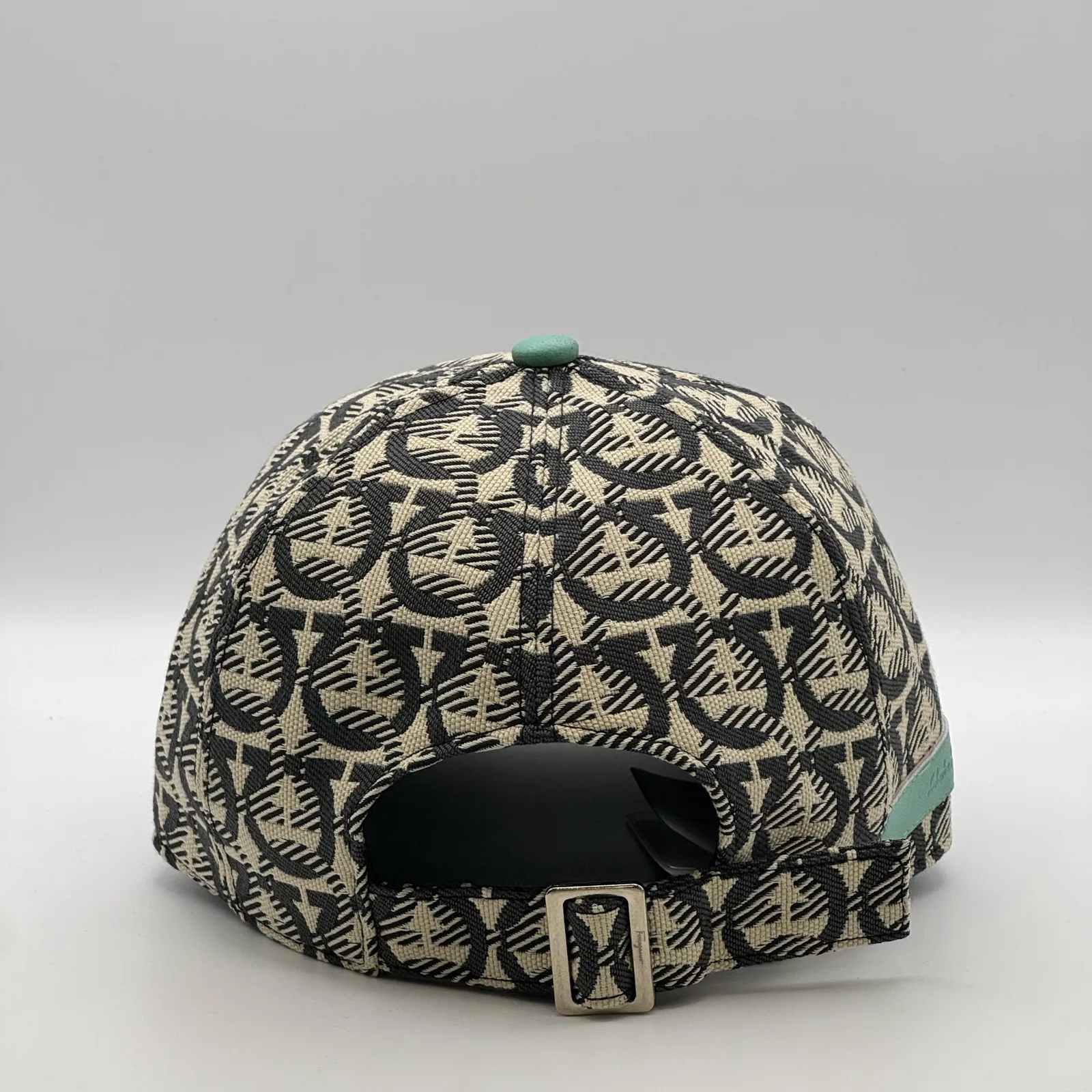 Ferragamo Gancini cap, back three-quarter view showing the engraved metal buckle.