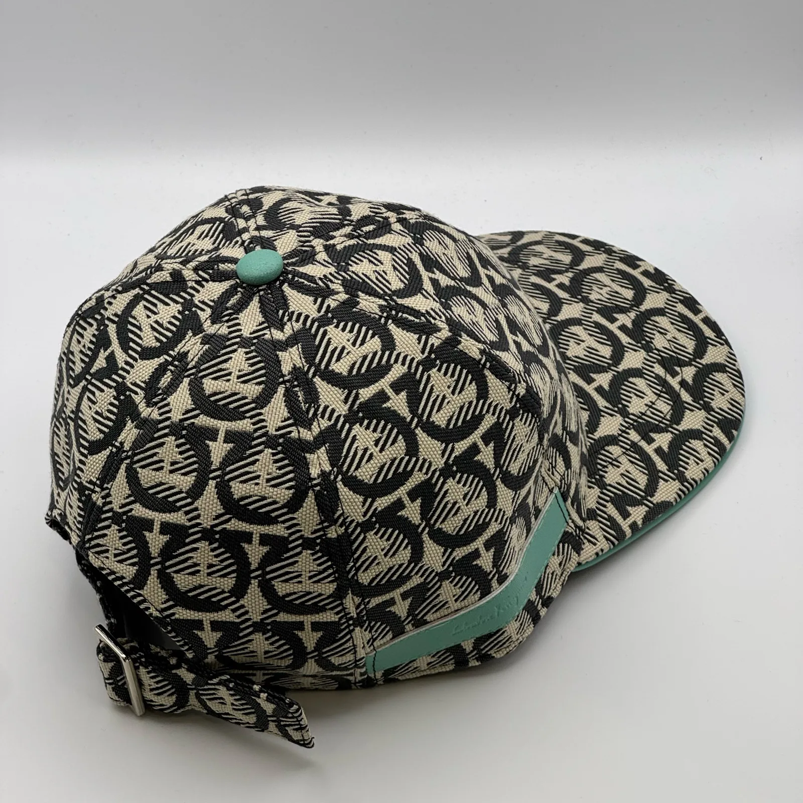 Ferragamo Gancini cap, rear side view showing the strap tab hanging free.