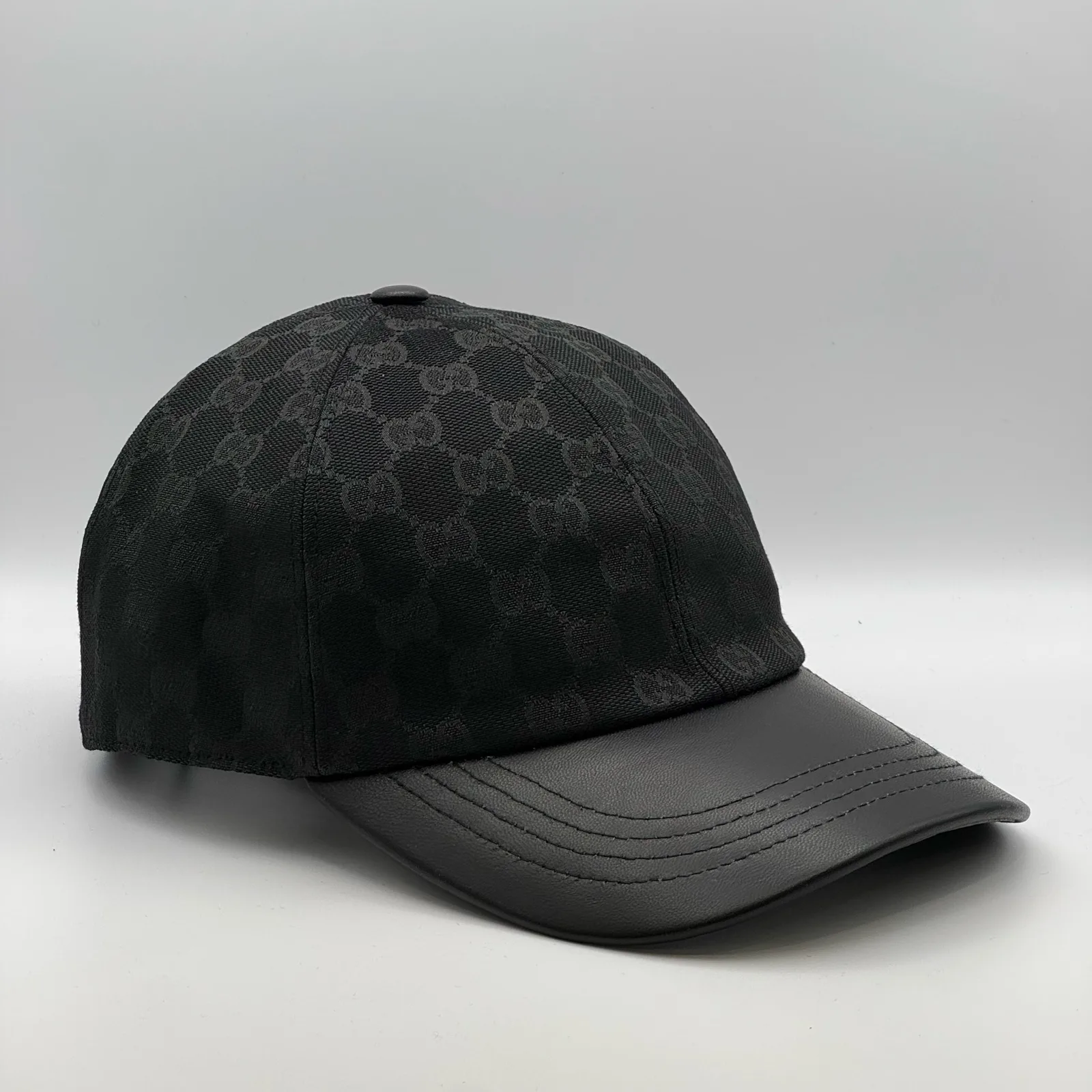 Black GG canvas cap, front view showing the bold GG jacquard pattern