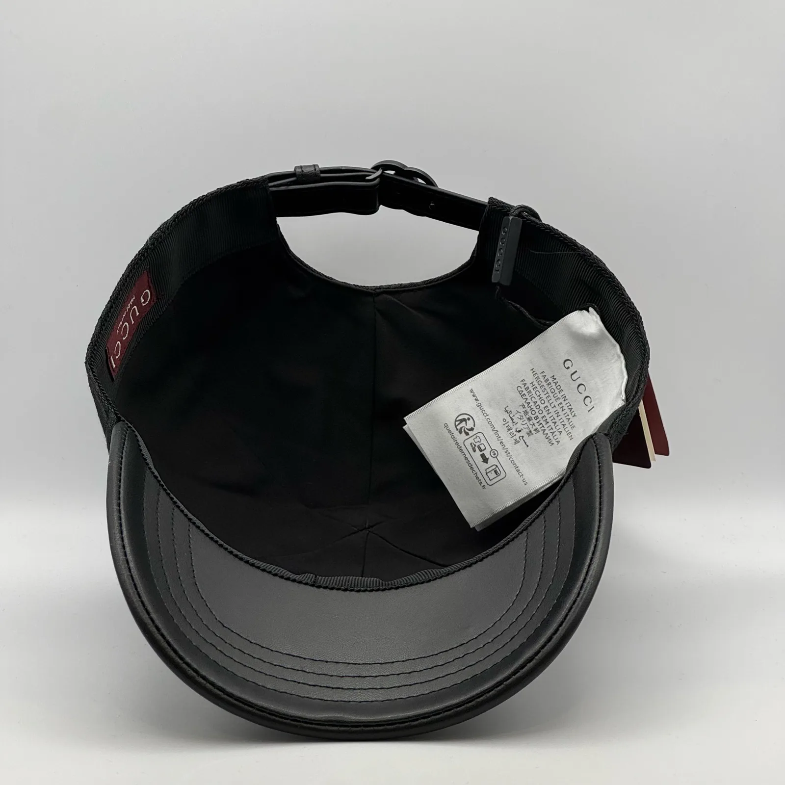 Black GG canvas cap, interior view with brand booklet and tag