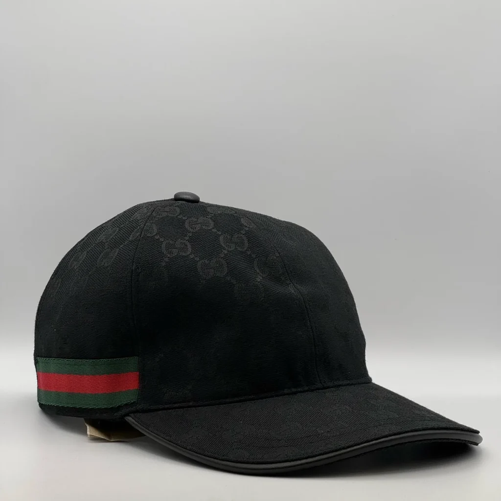 Black GG canvas cap, front three-quarter view with green and red web stripe trim