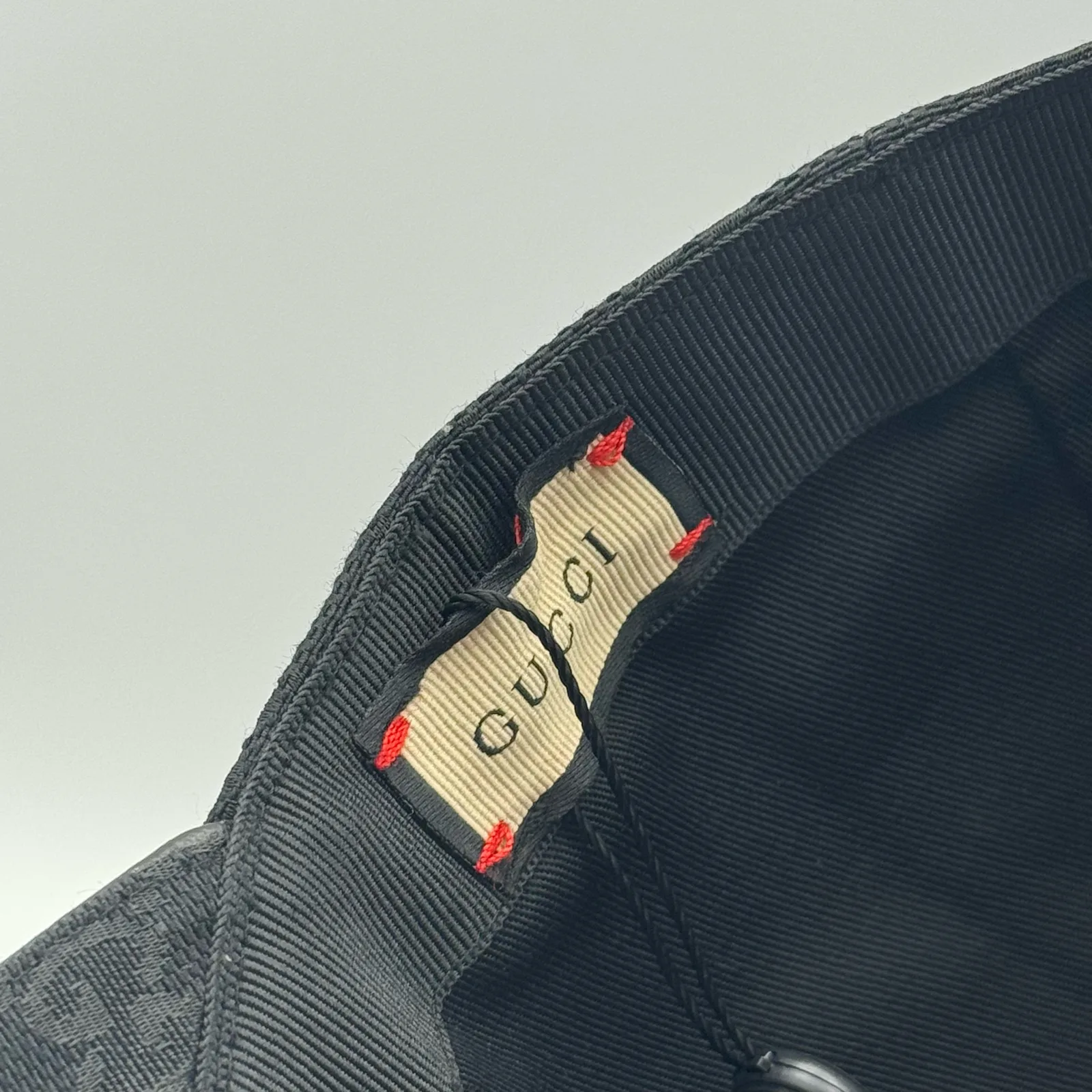 Black GG canvas cap, close-up of the woven interior brand tag