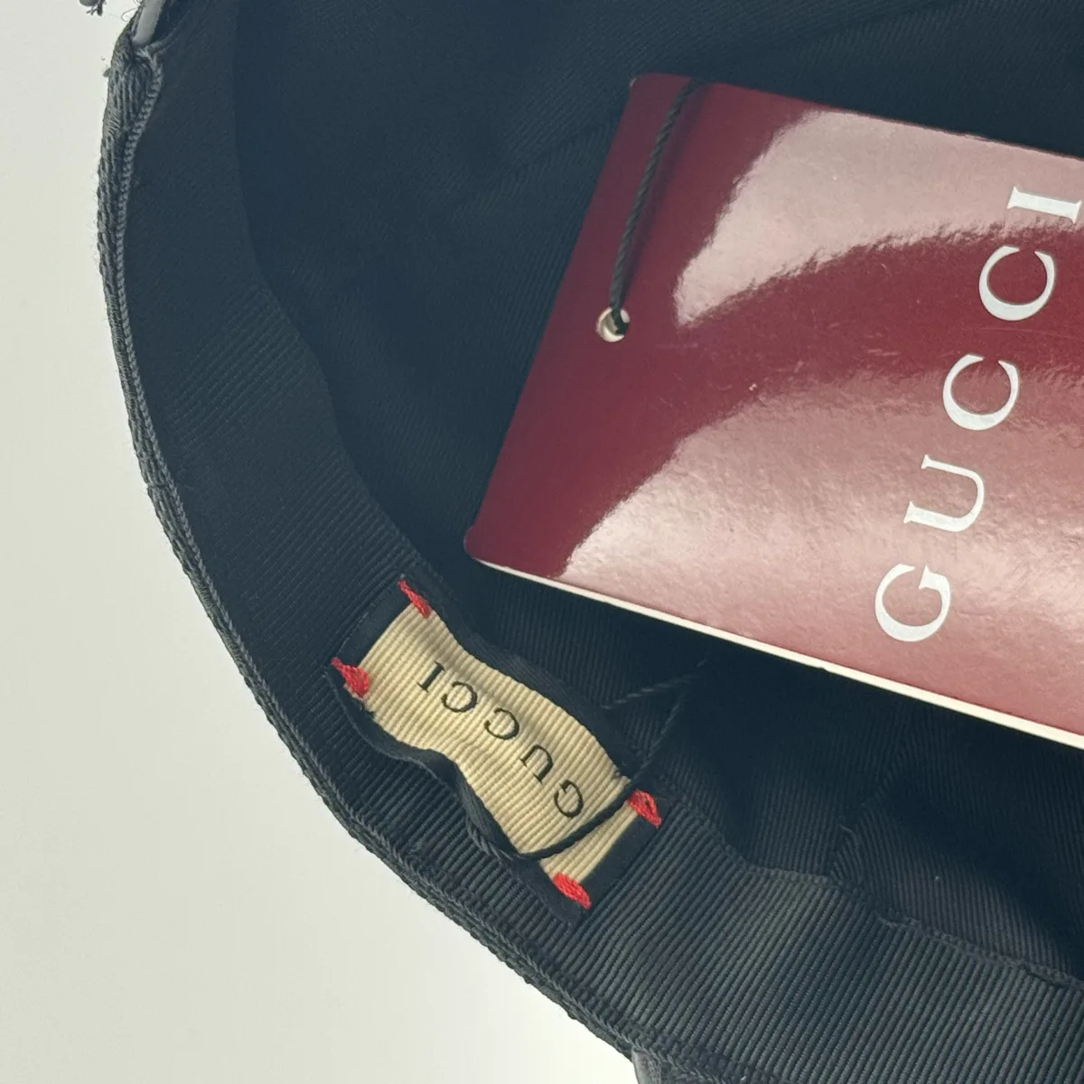 Black GG canvas cap, interior view with brand booklet and tag