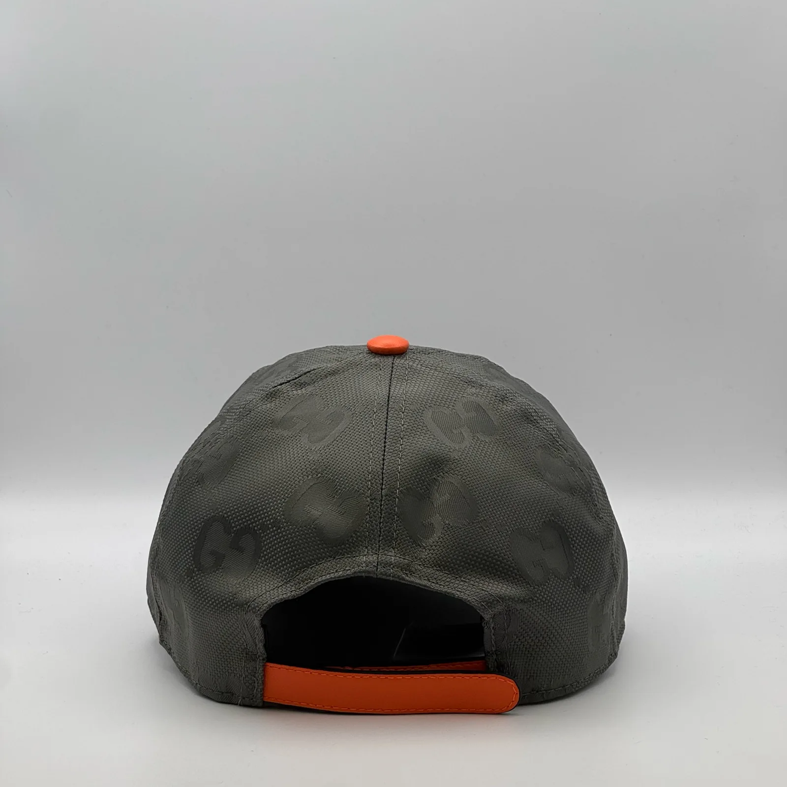 Grey GG cap, back view with orange strap tab