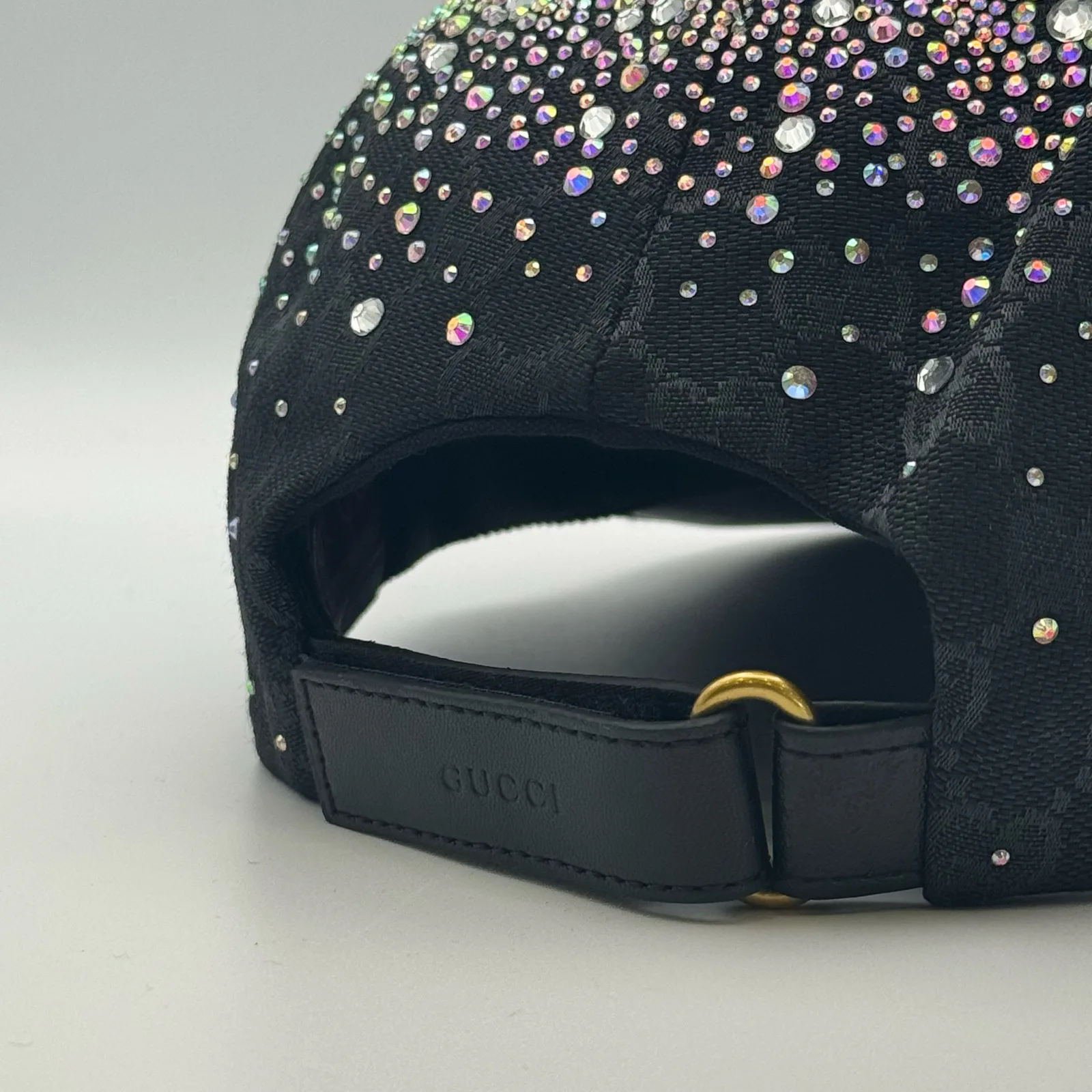 Close-up of leather strap closure with Gucci embossing and gold-tone hardware