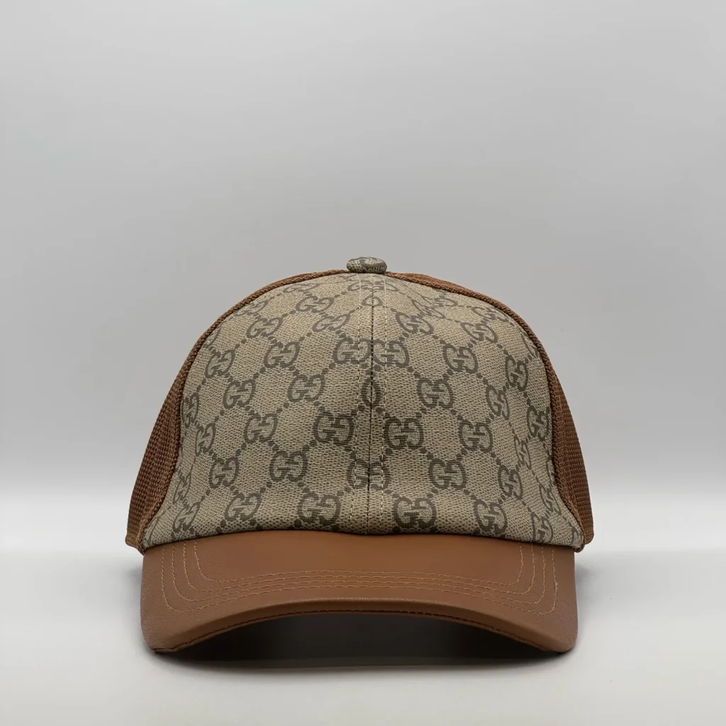 Brown GG canvas trucker cap with tan leather brim, front view