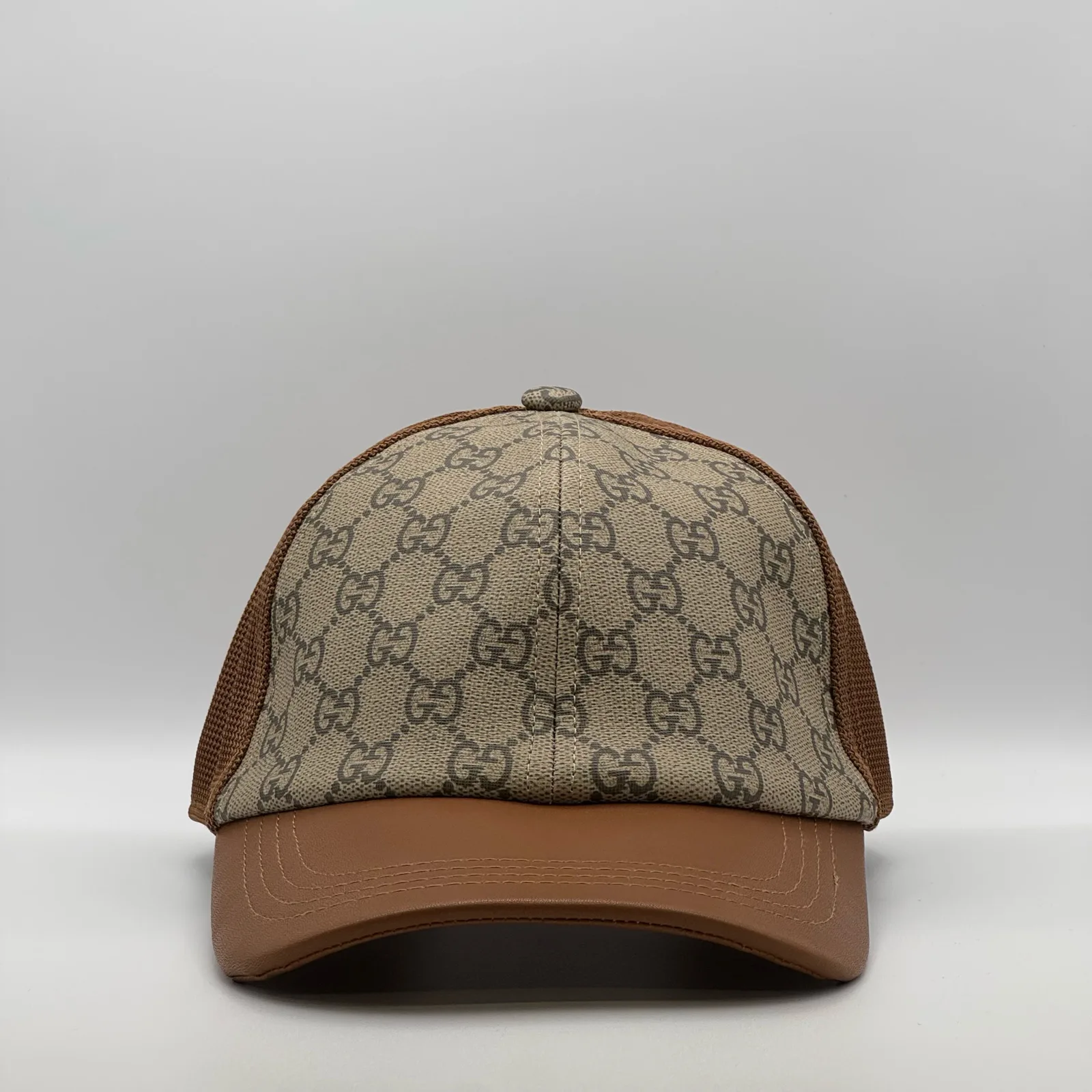 Brown GG canvas trucker cap with tan leather brim, front view