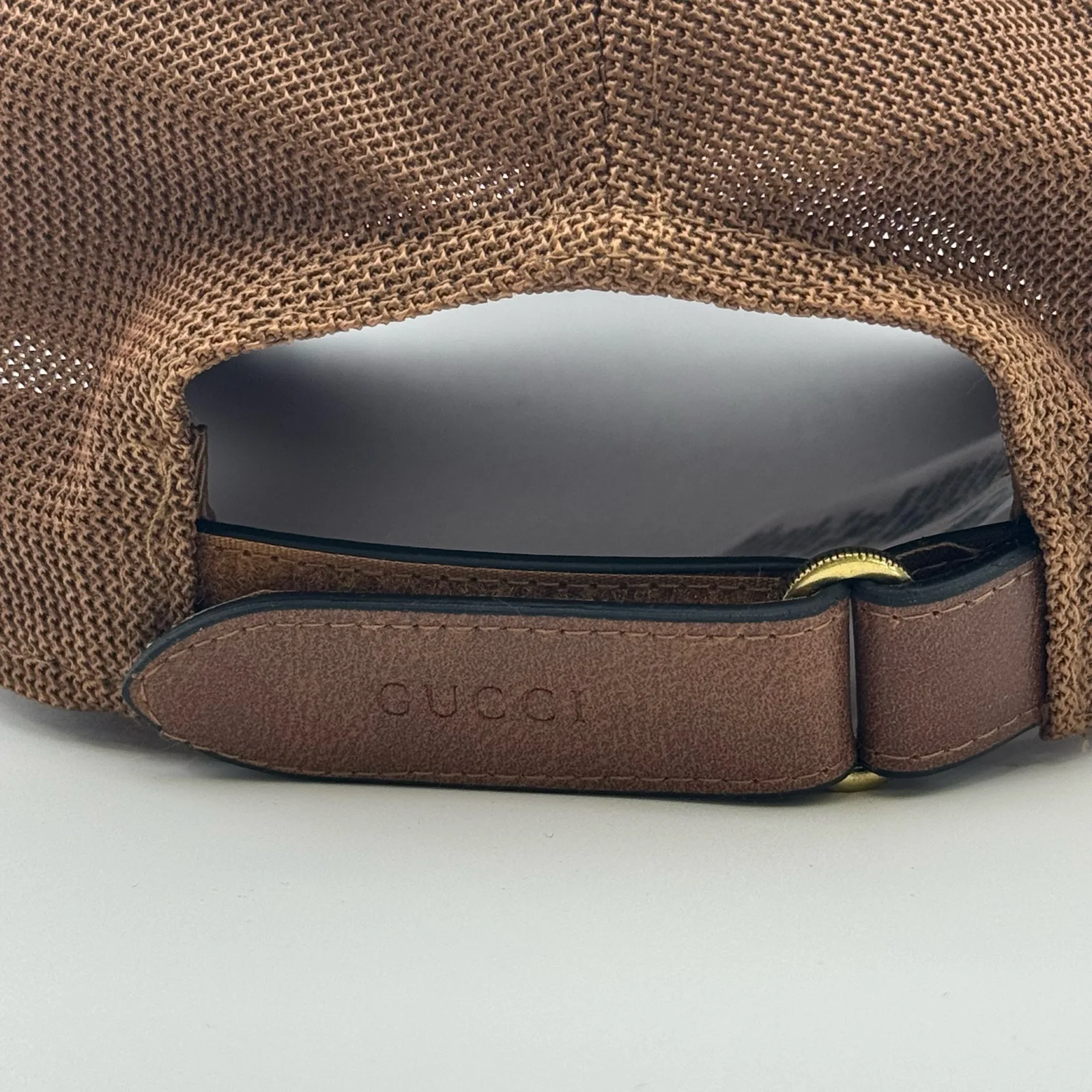 Close-up of leather strap closure with Gucci embossing