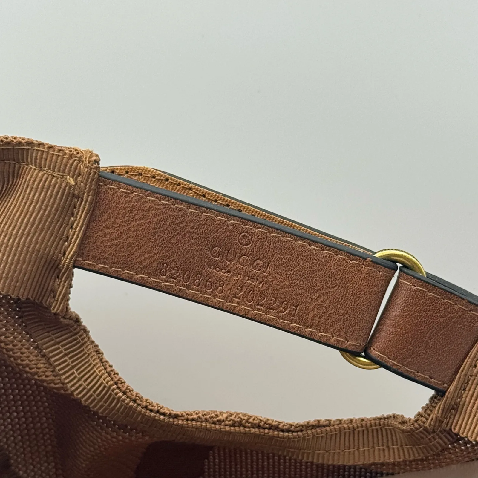 Close-up of adjustable strap buckle with gold-tone hardware
