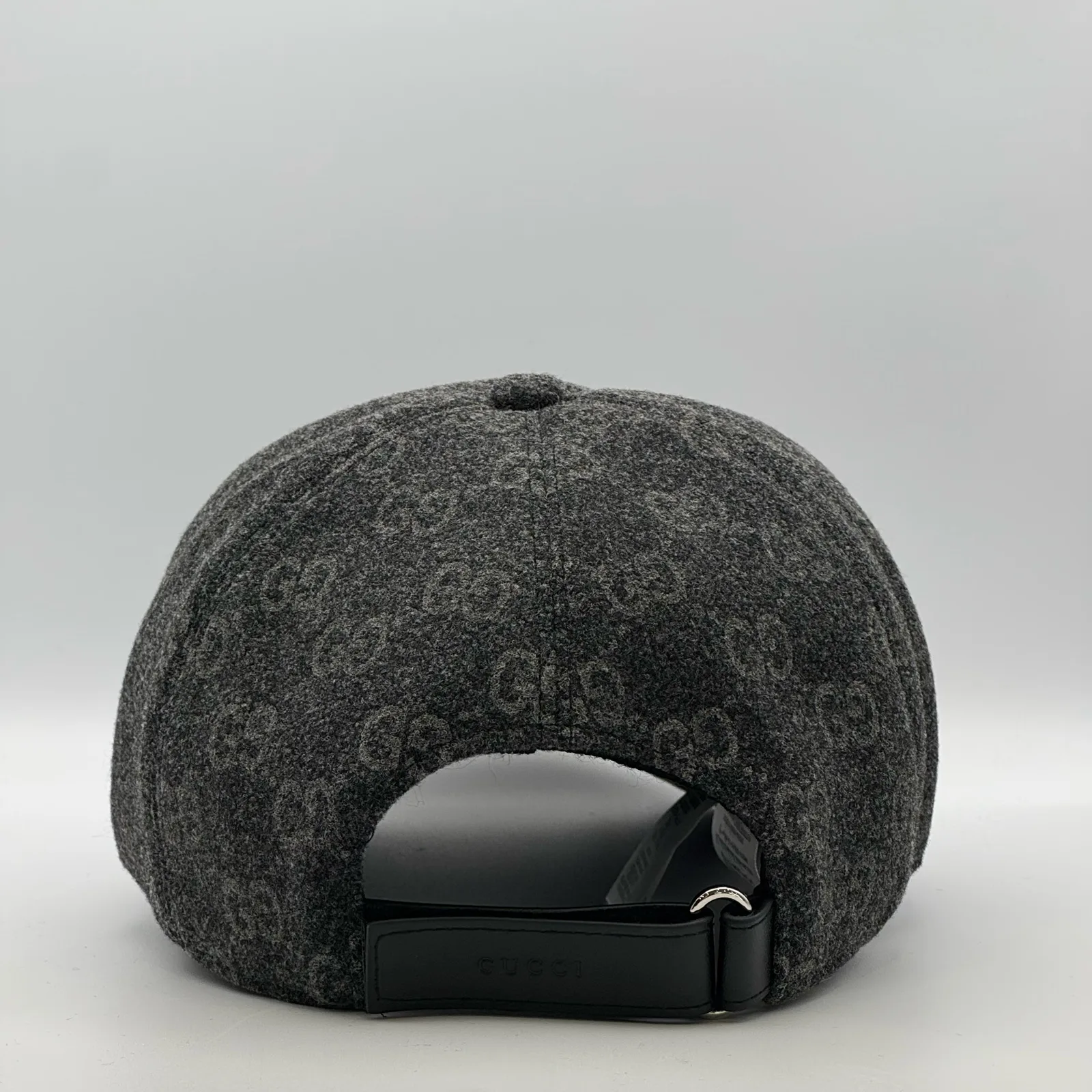 Charcoal GG wool cap, back view with leather strap closure