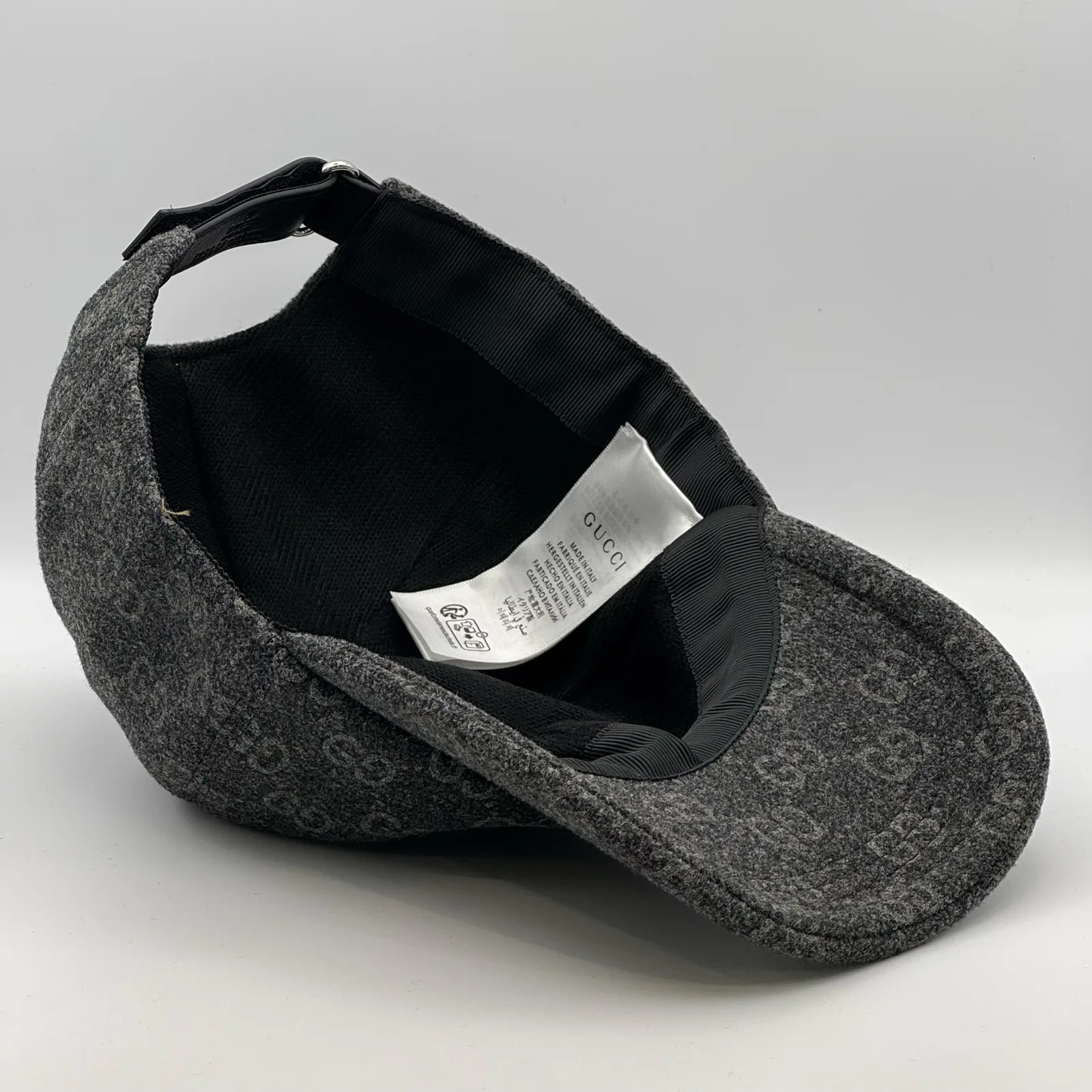 Charcoal GG wool cap interior, brim and care label visible
