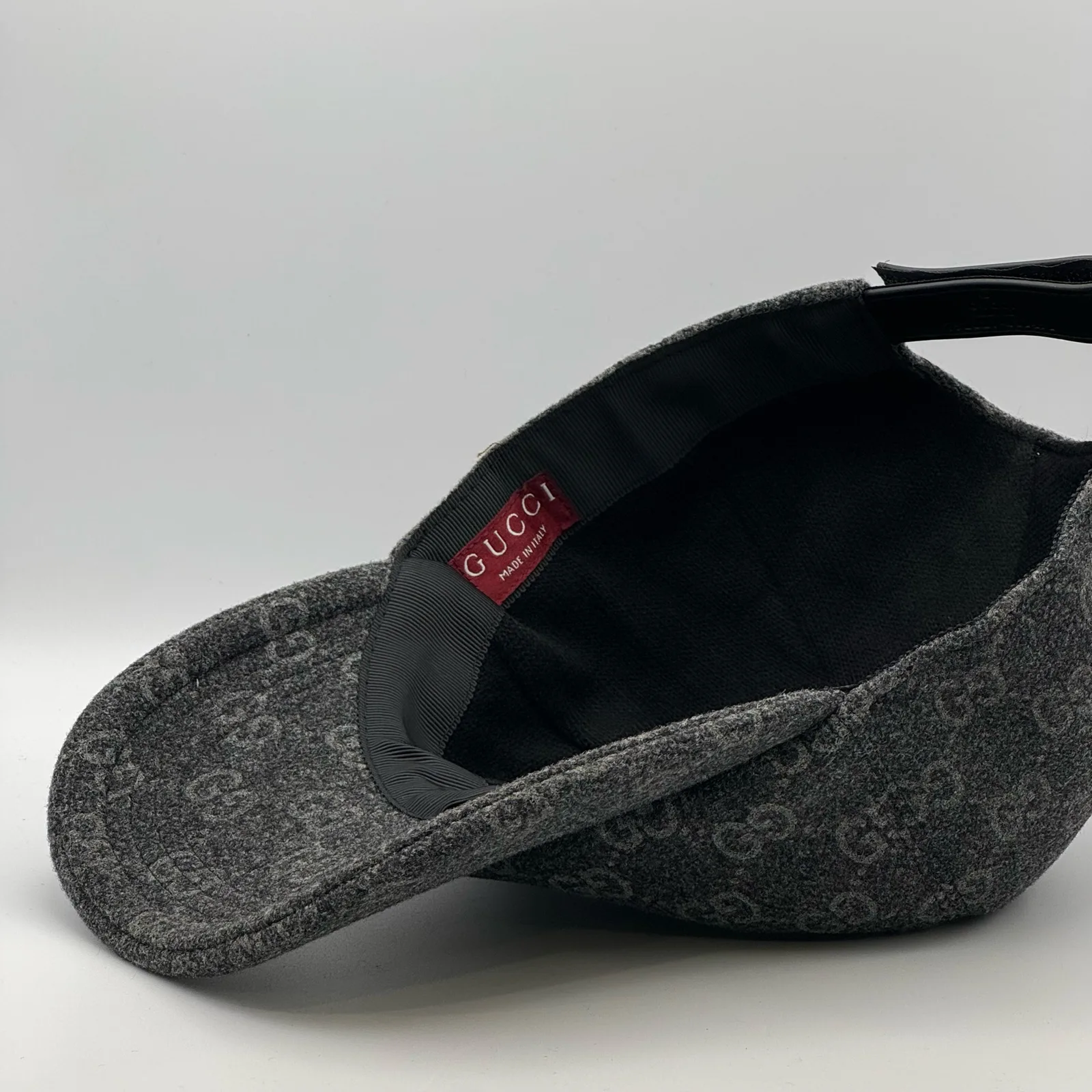Charcoal GG wool cap interior, red brand tag on lining