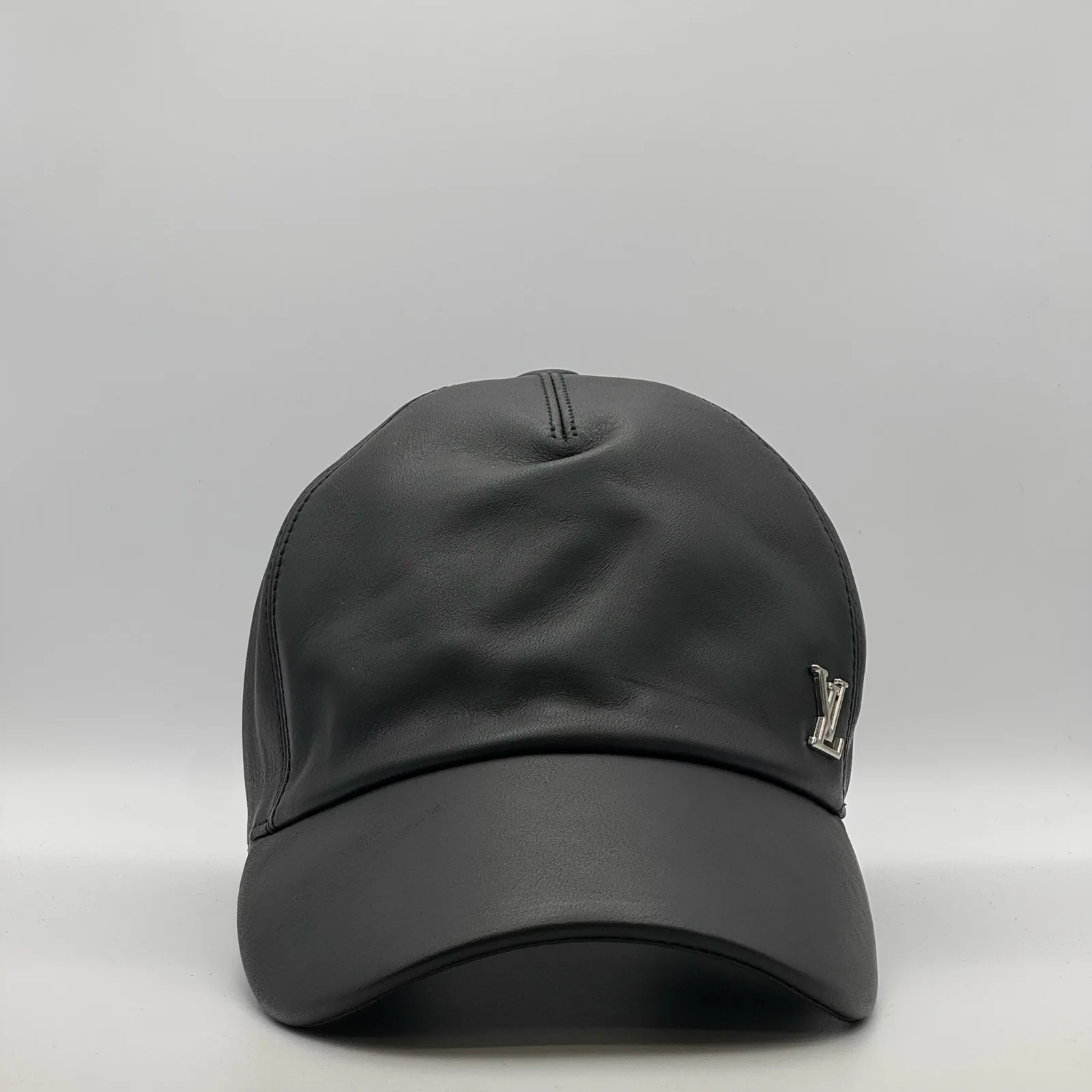 Black leather Louis Vuitton cap, three-quarter front view.