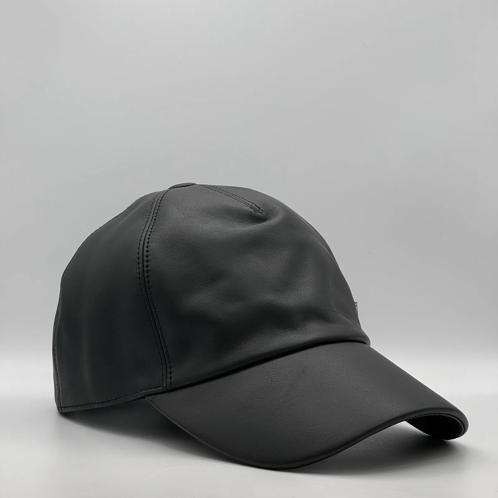 Black leather cap, side profile view.