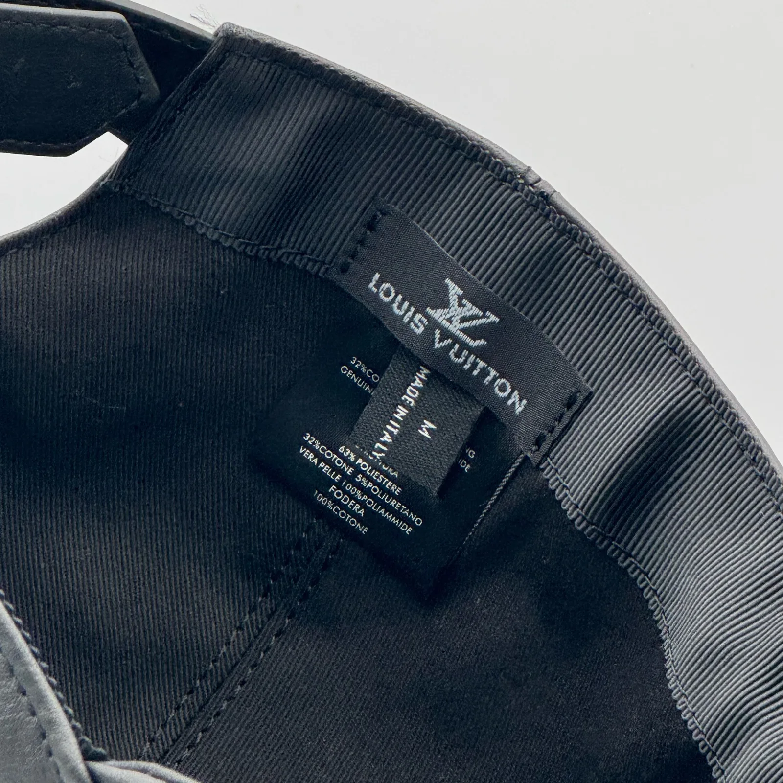 Close-up of the interior label on the black leather cap.