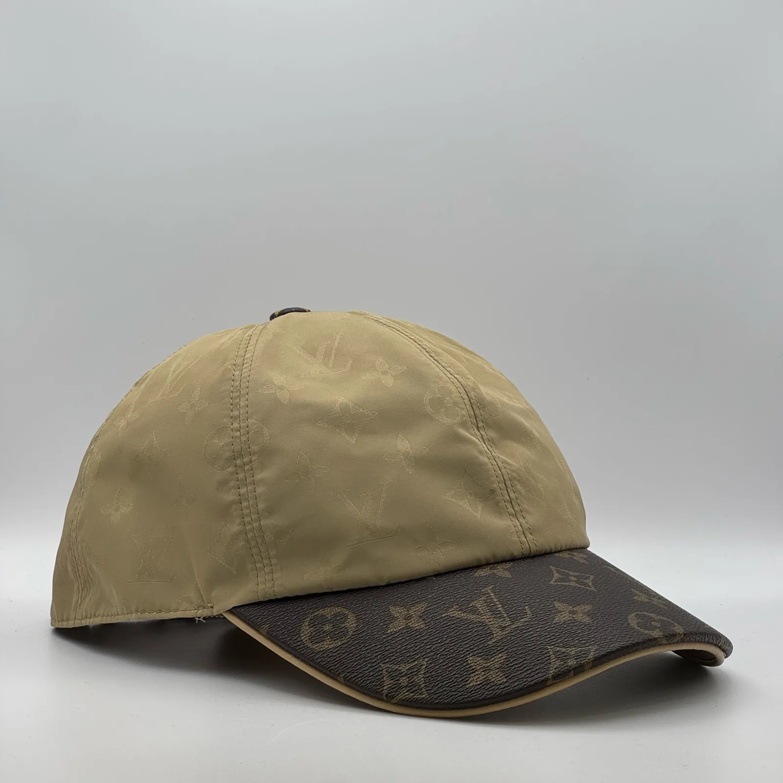 Beige Louis Vuitton Monogram Brim cap, three-quarter view showing the monogram canvas brim.