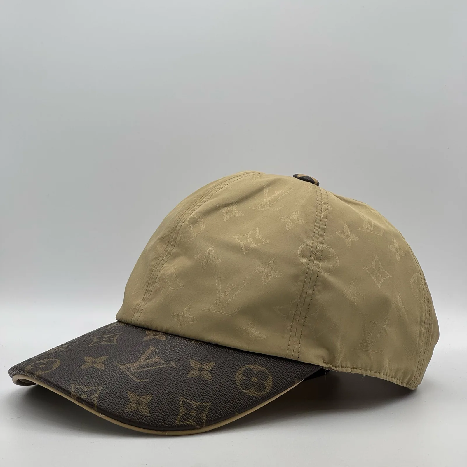 Beige monogram brim cap, side profile view.