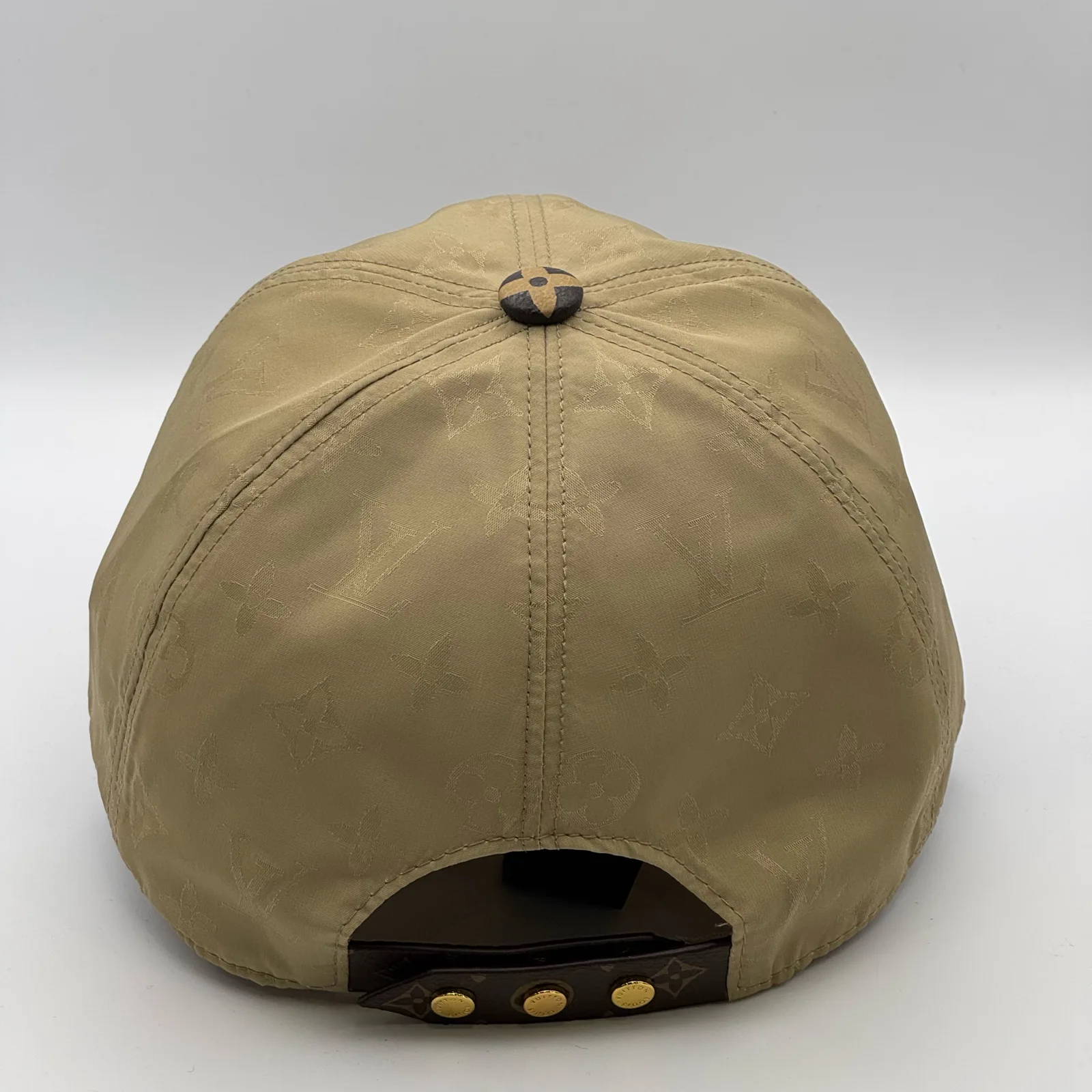 Beige monogram brim cap, top-down view of the crown.