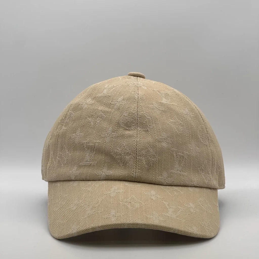 Beige Louis Vuitton Monogram cap, front view showing the tonal jacquard pattern.