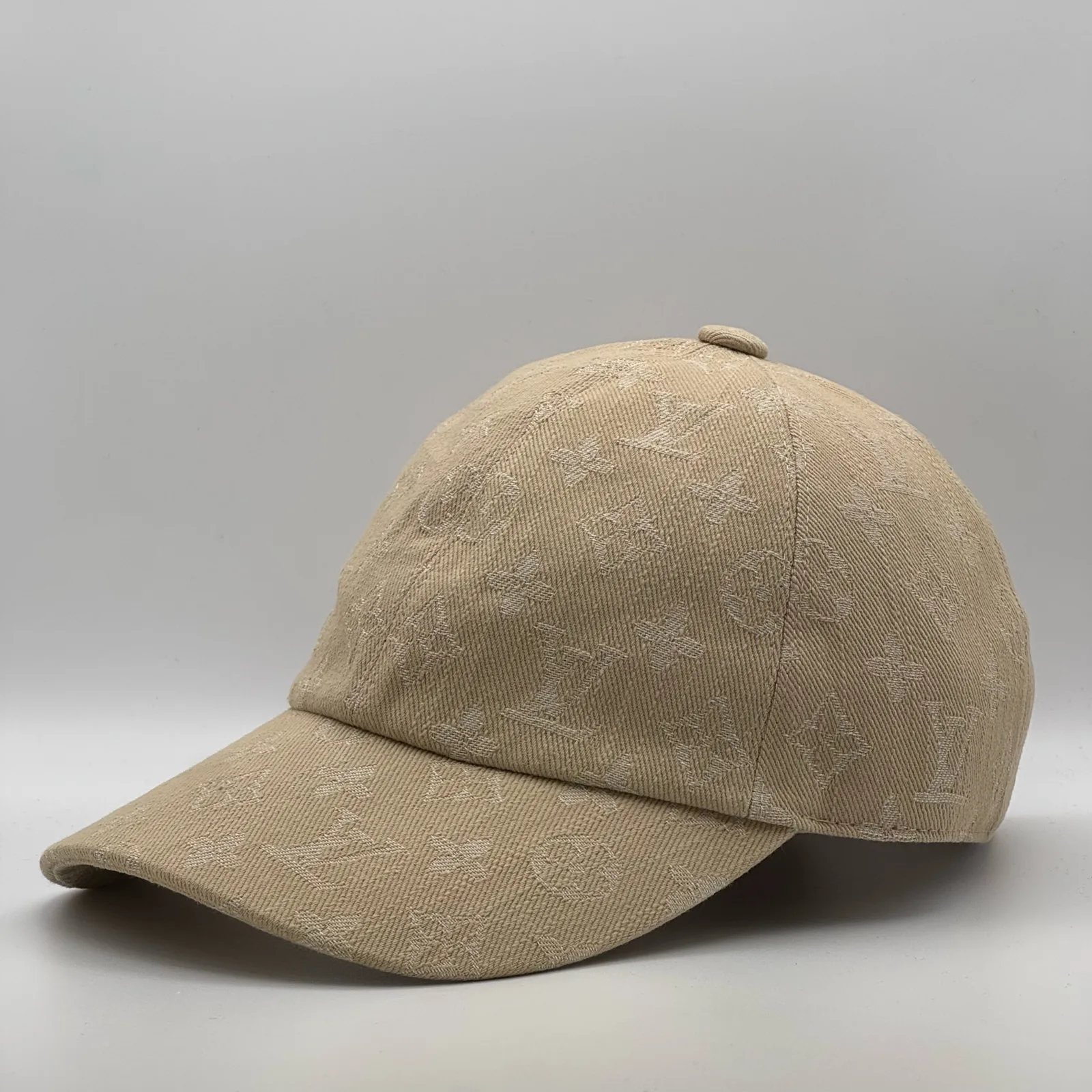 Beige monogram cap, side profile view.