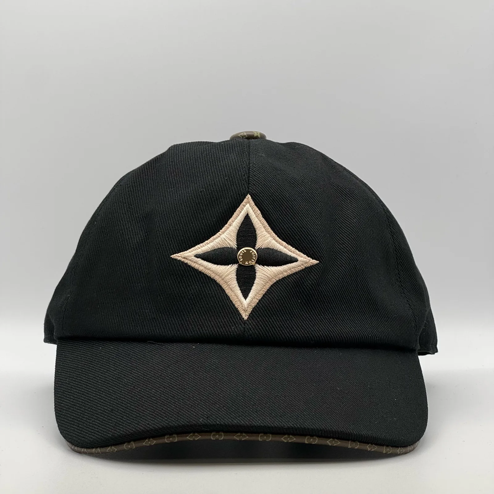 Black LV Monogram Flower cap, front view showing the flower emblem on the crown.