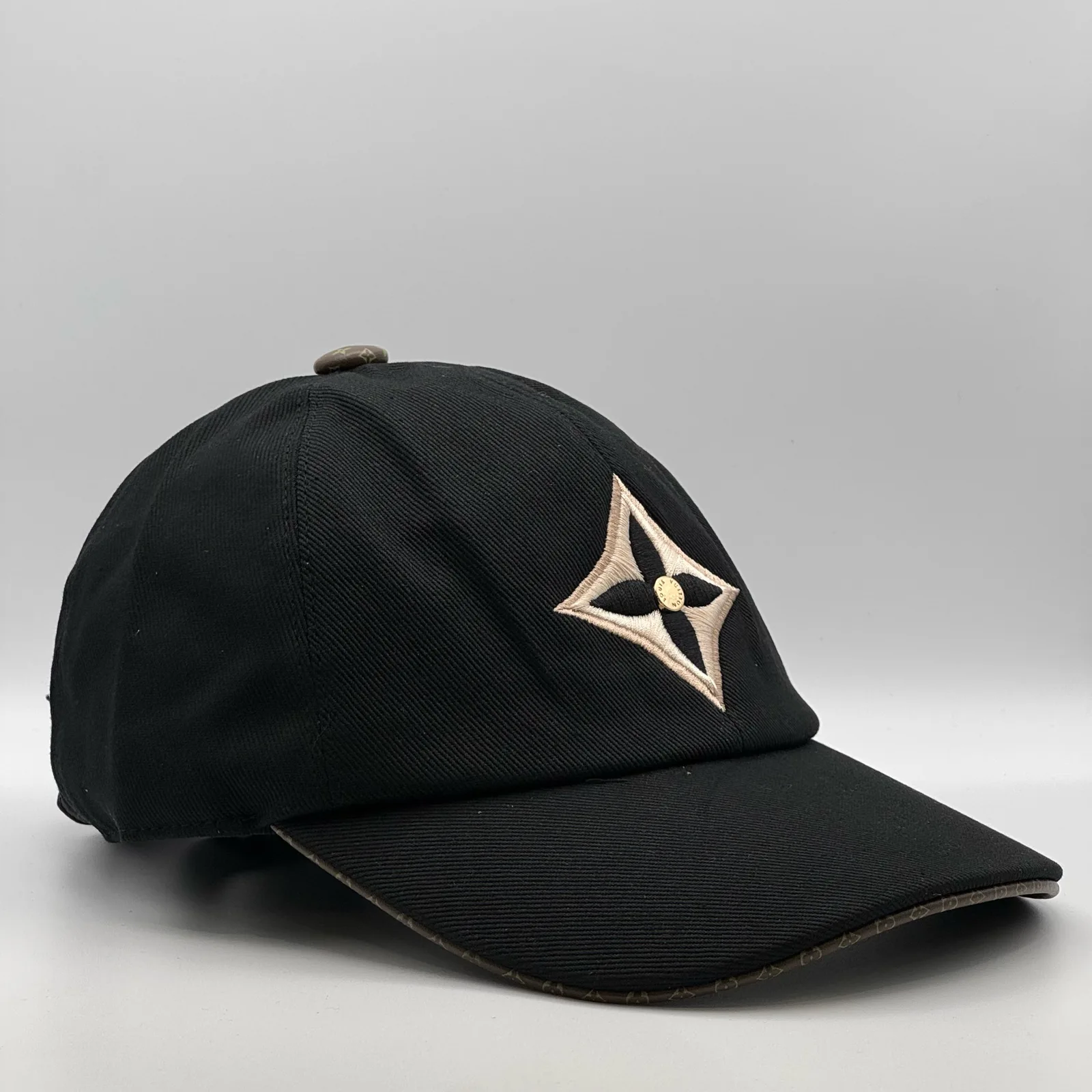 Black LV Monogram Flower cap, side profile view.