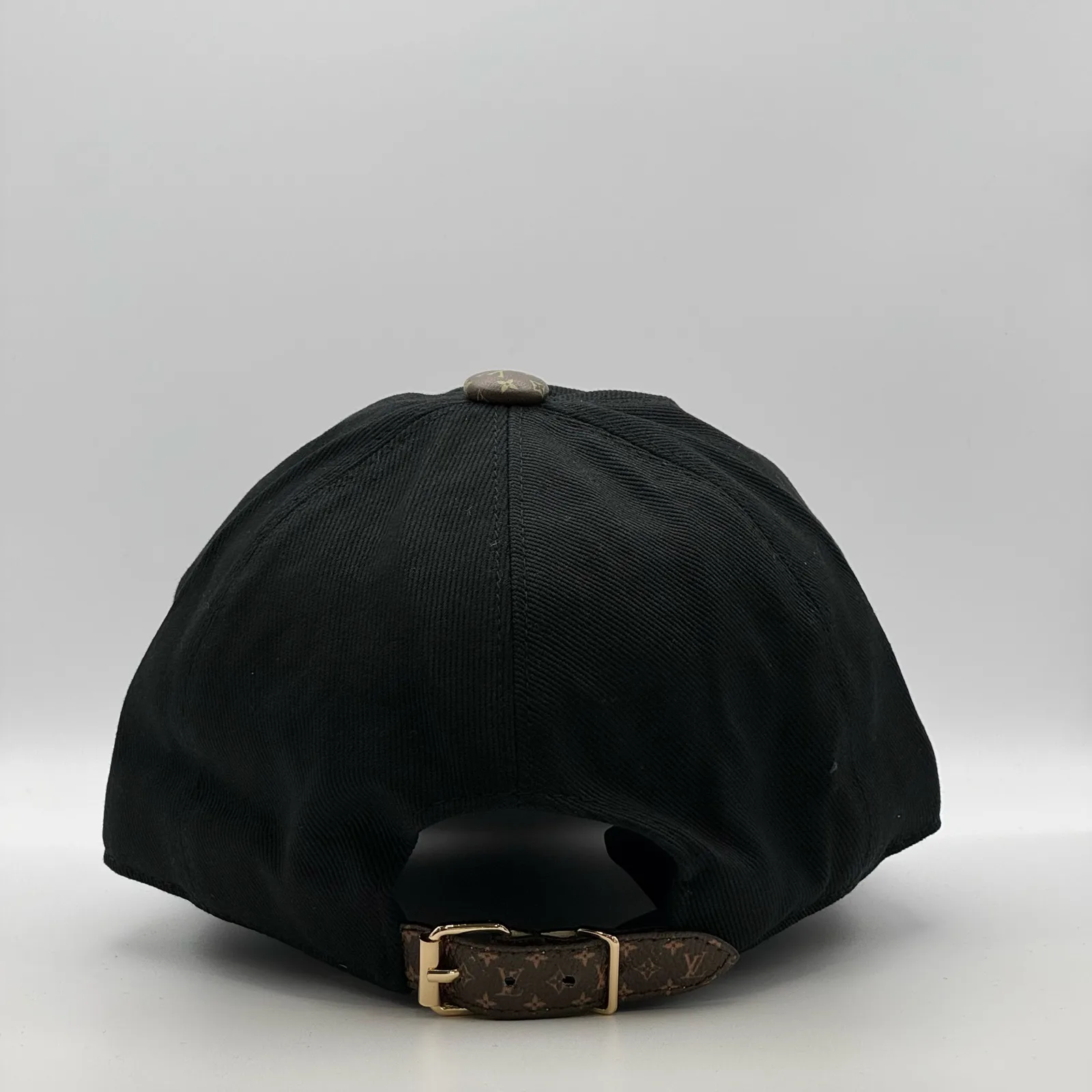 Black LV Monogram Flower cap, back view showing the adjustable strap.