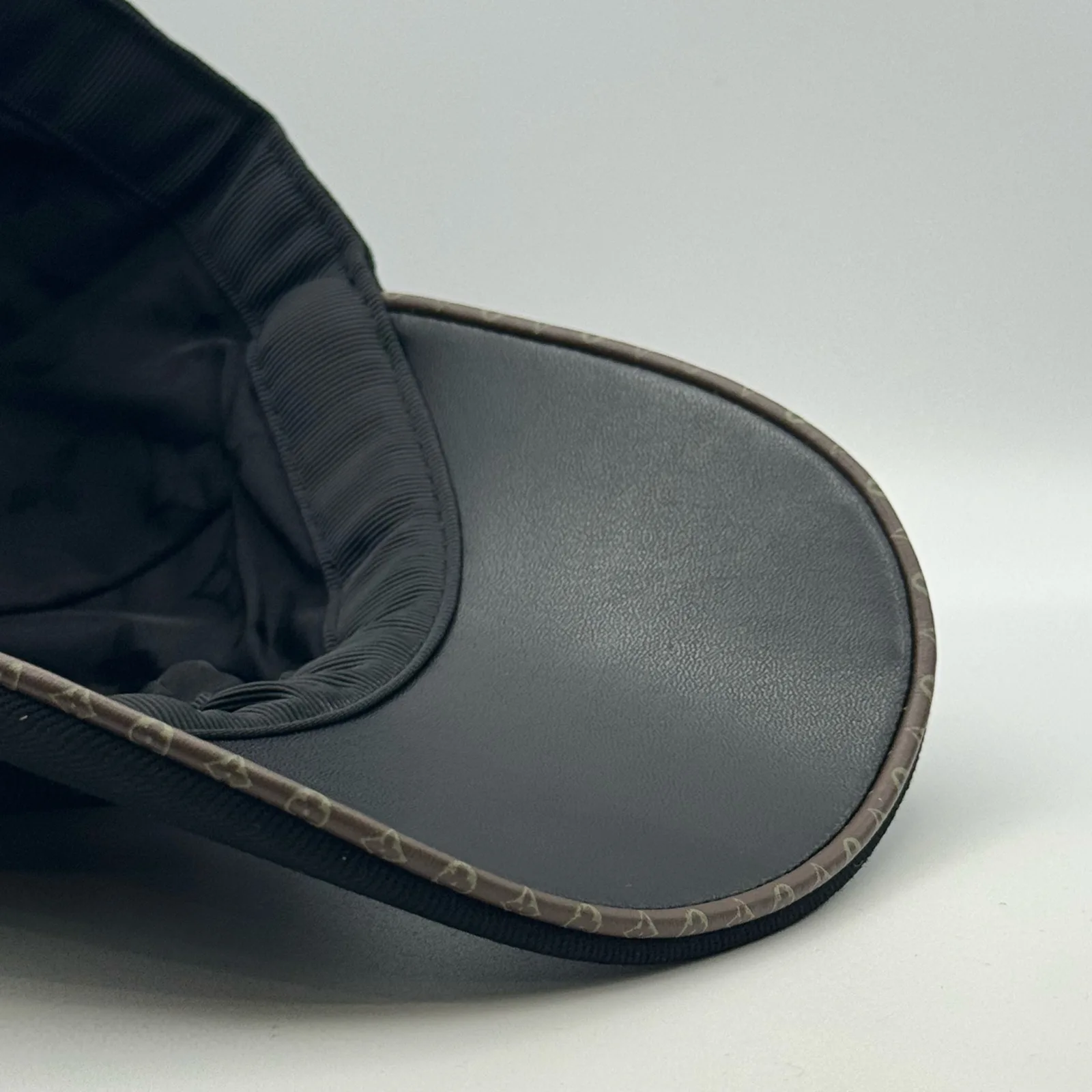 Close-up of the underbrim and leather trim on the black flower cap.