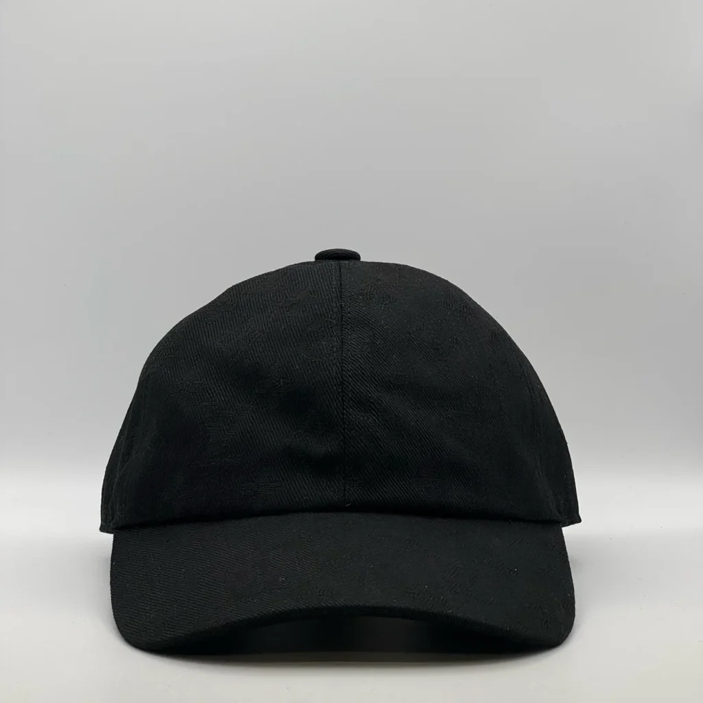 Black monogram jacquard cap, front view.